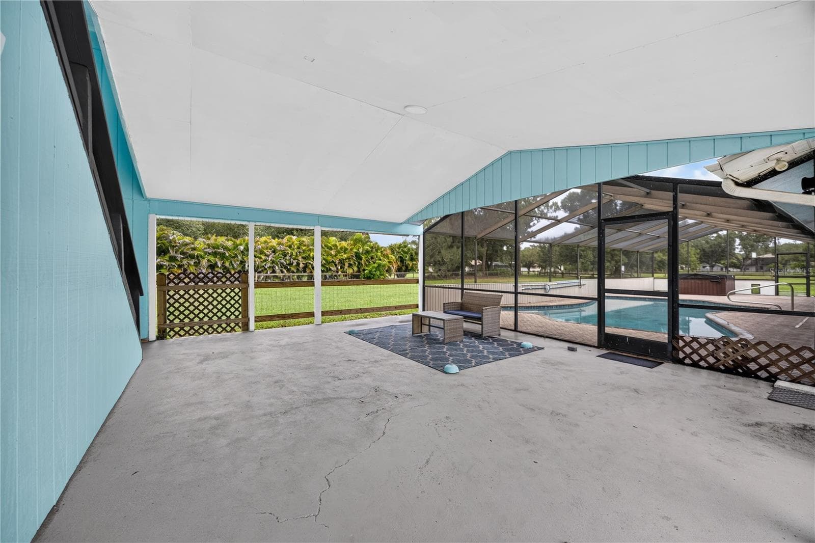 Covered patio and poolside gathering space. - 1305 GREENFIELD CIR, VENICE