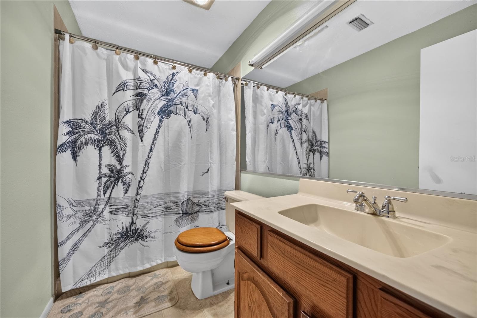 Upstairs bathroom vanity and tub/shower. - 1305 GREENFIELD CIR, VENICE