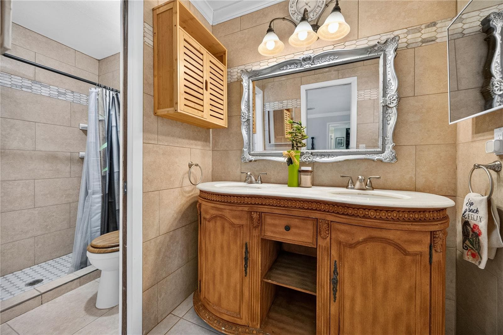Upstairs bathroom vanity and storage. - 1305 GREENFIELD CIR, VENICE