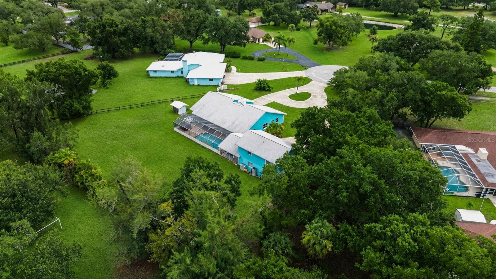 Aerial view of the pool, residence and surrounding property. - 1305 GREENFIELD CIR, VENICE