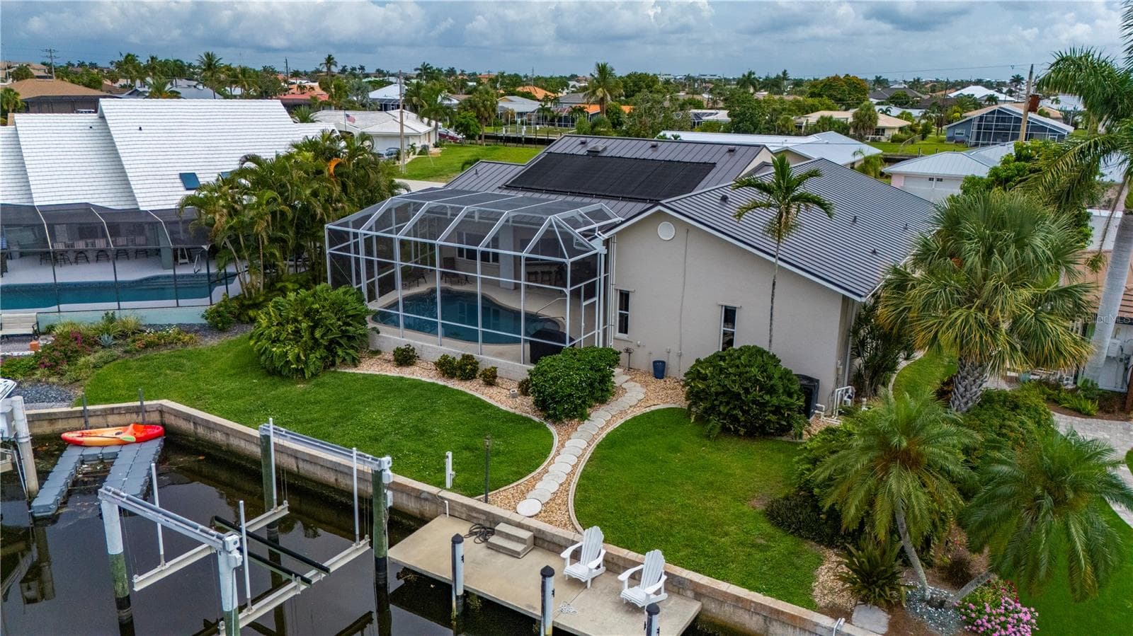 Rear view, mature tropical landscaping surrounds - 265 BELVEDERE CT, PUNTA GORDA