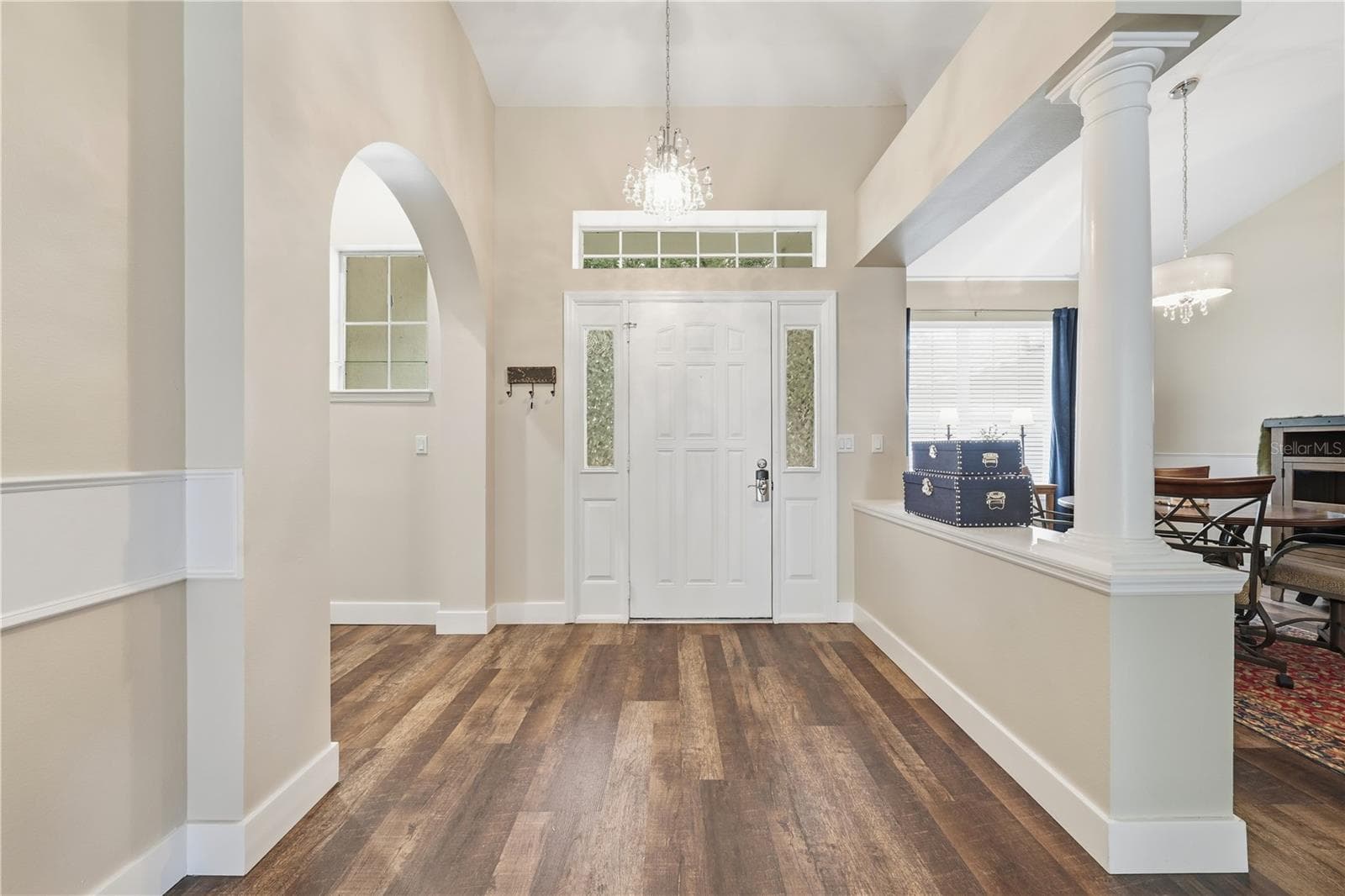 A warm welcome begins the moment you step inside the foyer with crystal light fixture. - 2360 PARK FOREST BLVD, MOUNT DORA