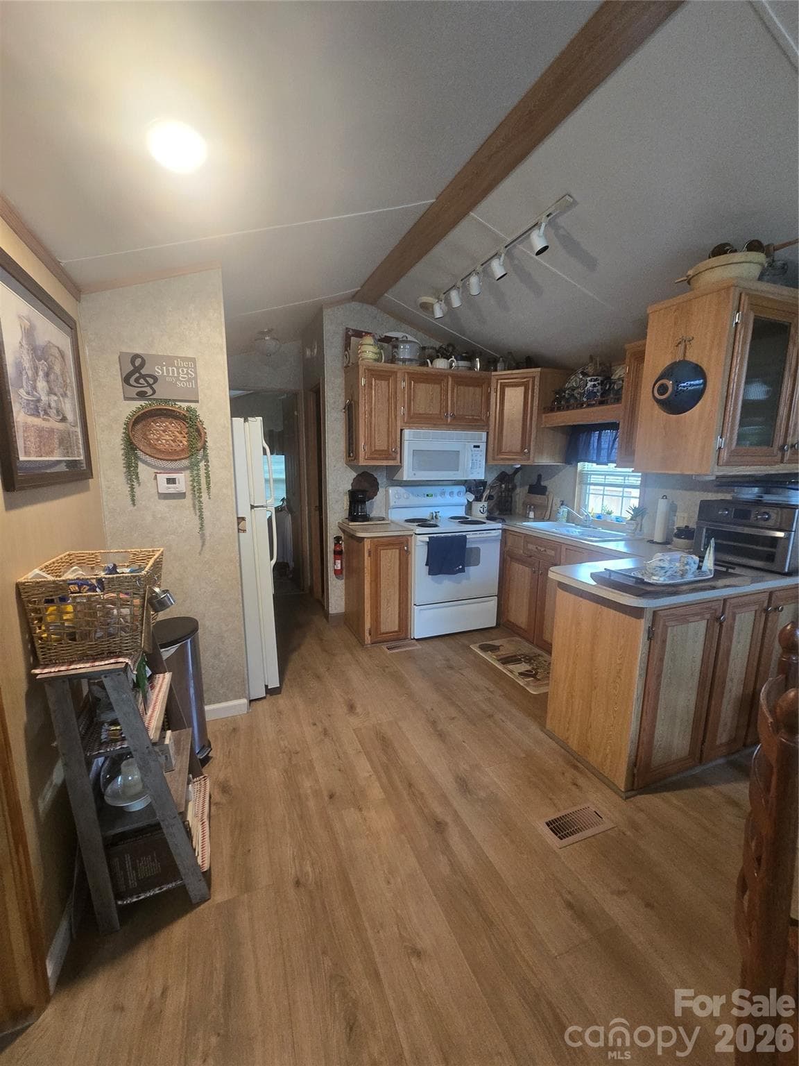 Kitchen w bar and trac light s above. Refrigerator to left will convey - 110 Twin Bluff Trail, Mount Gilead