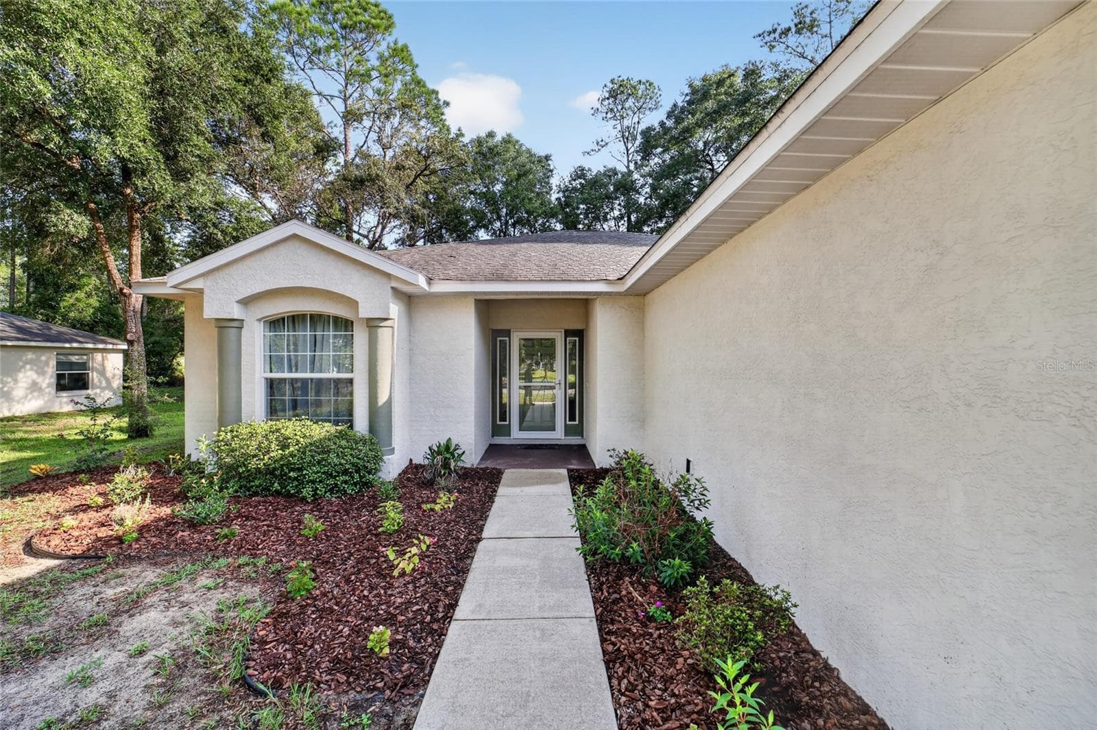 Front door with landscaping - 19369 SW 100TH LOOP, DUNNELLON