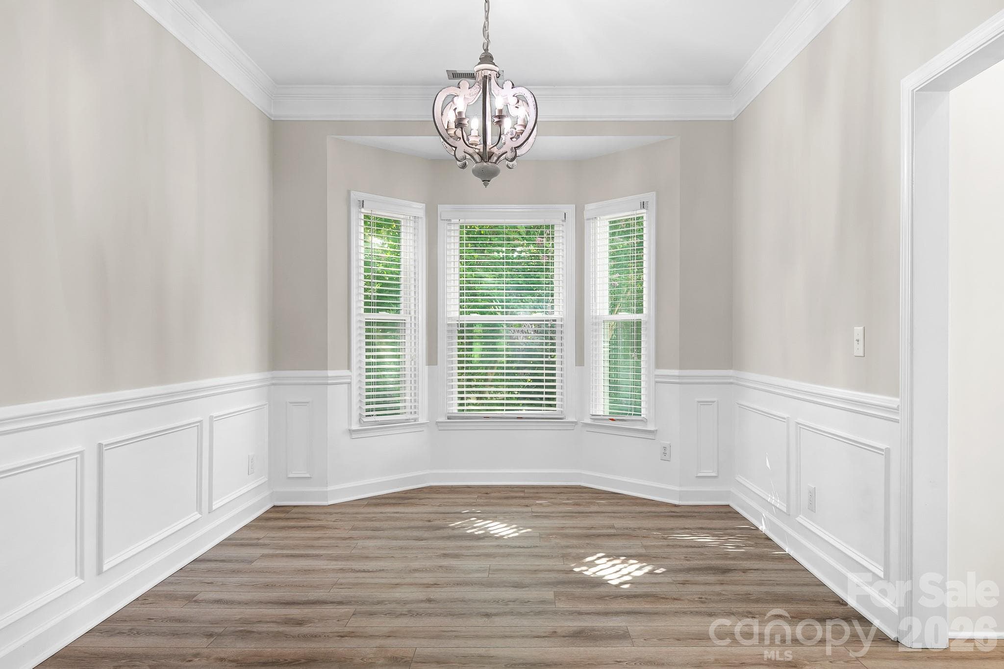 Dining Room with bay window, designer chandelier. Fresh paint and solid LVP flooring. - Cornelius