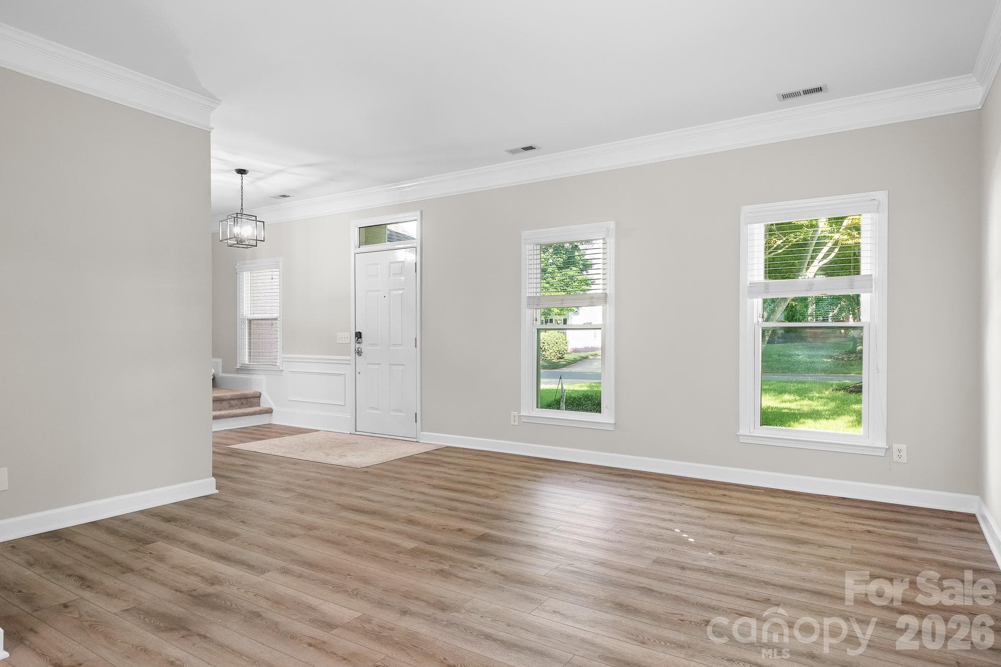 Front door area from Living Room. Foyer and stairs to the side. - Cornelius