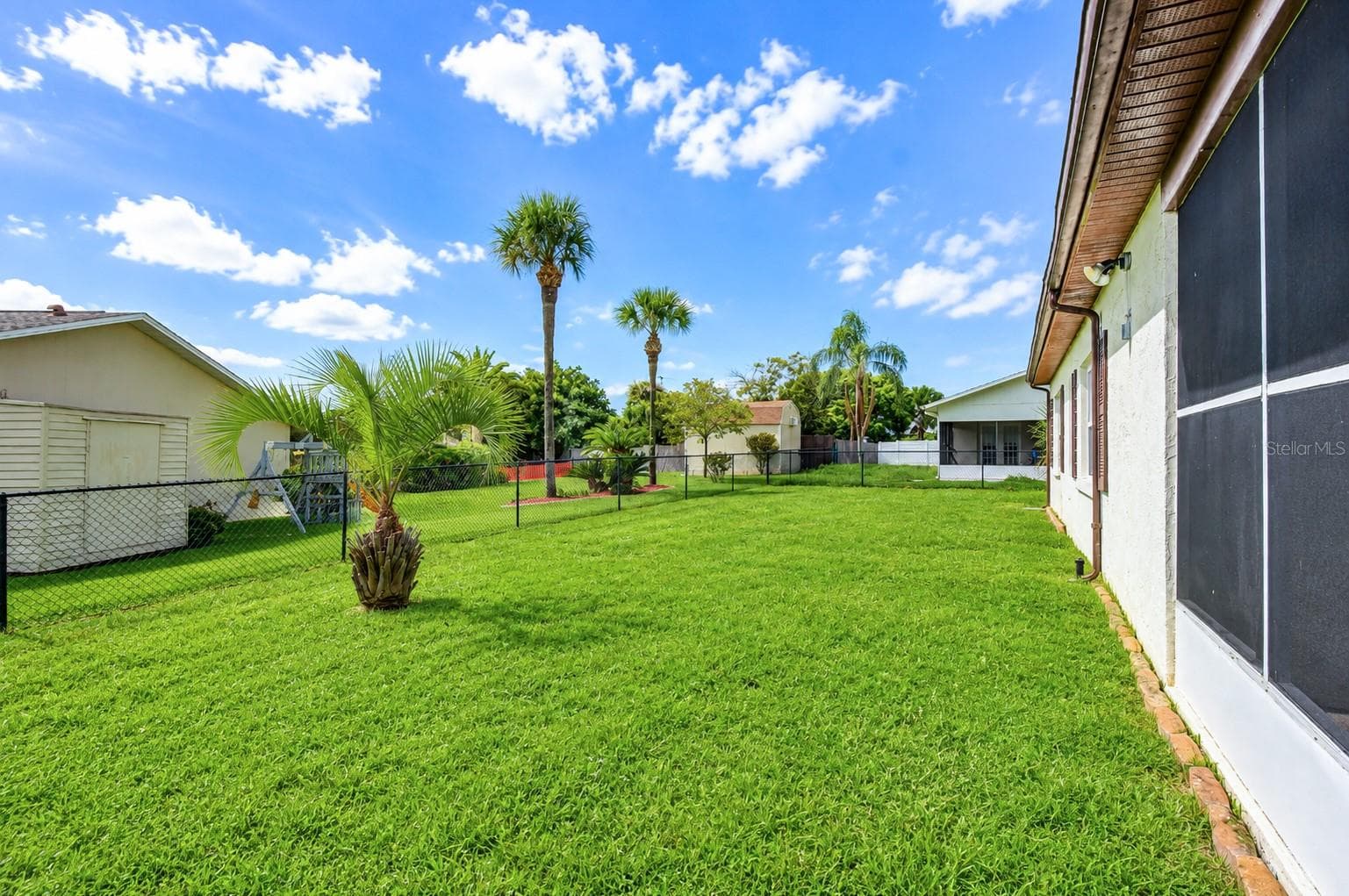 Patio leads to the backyard area - 8811 MARTINIQUE LN, PORT RICHEY