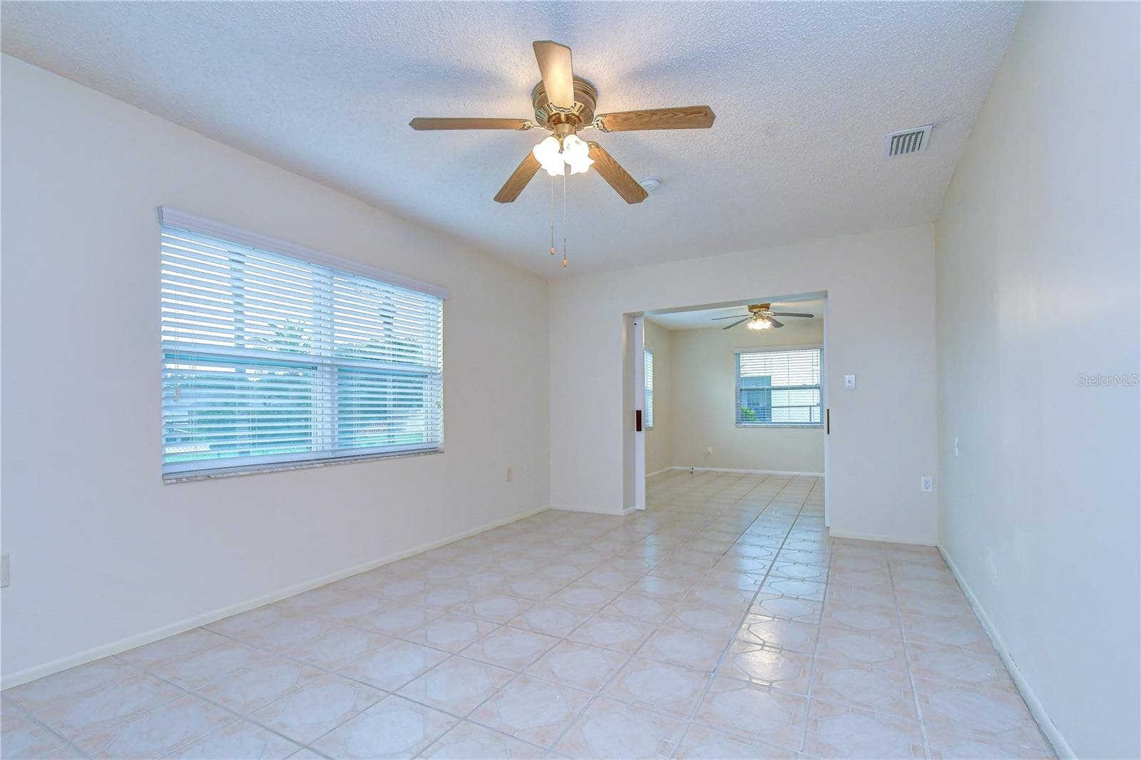 guest bedroom #1 with barn doors and access to patio - 8811 MARTINIQUE LN, PORT RICHEY
