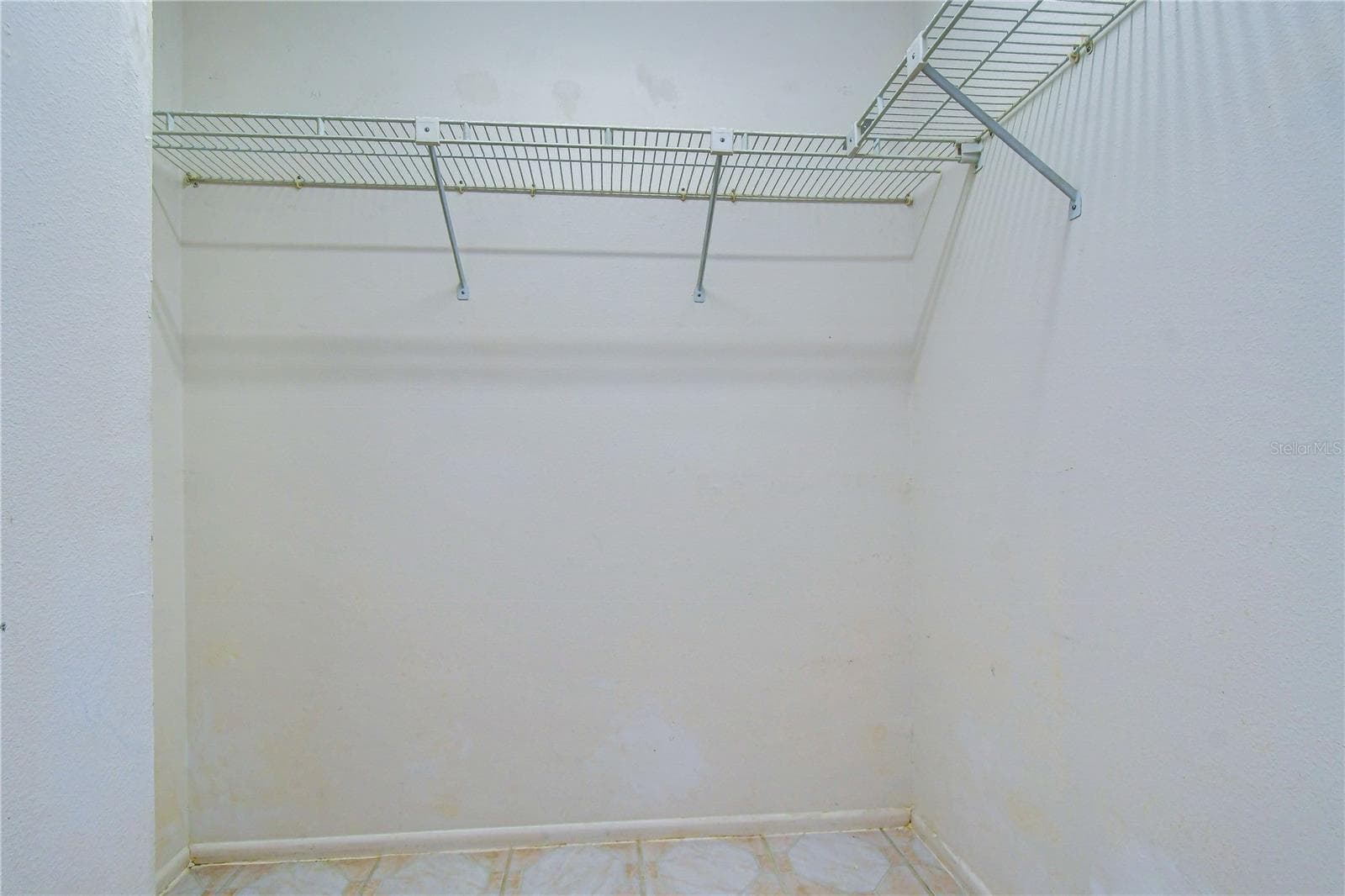 Primary bedroom closet - 8811 MARTINIQUE LN, PORT RICHEY