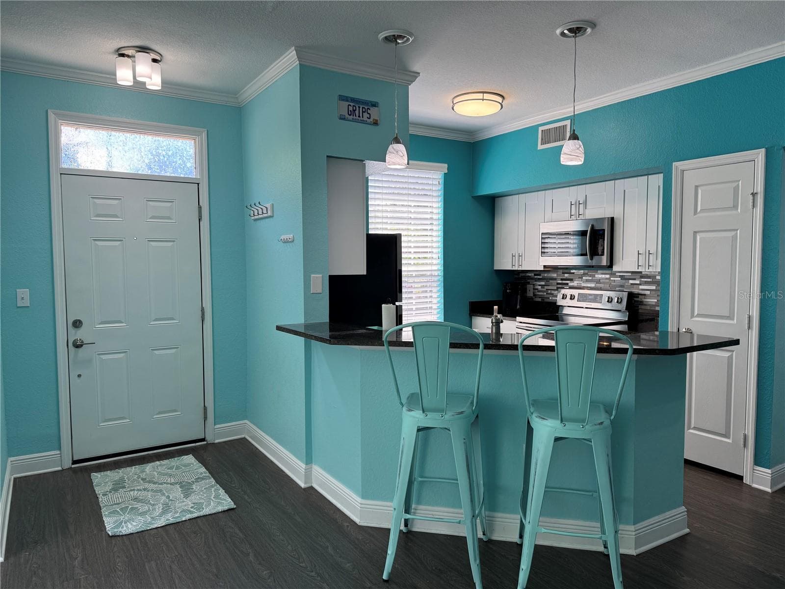 Kitchen with SS appliances & breakfast/serving bar! - 9288 LAKE CHASE ISLAND WAY, TAMPA