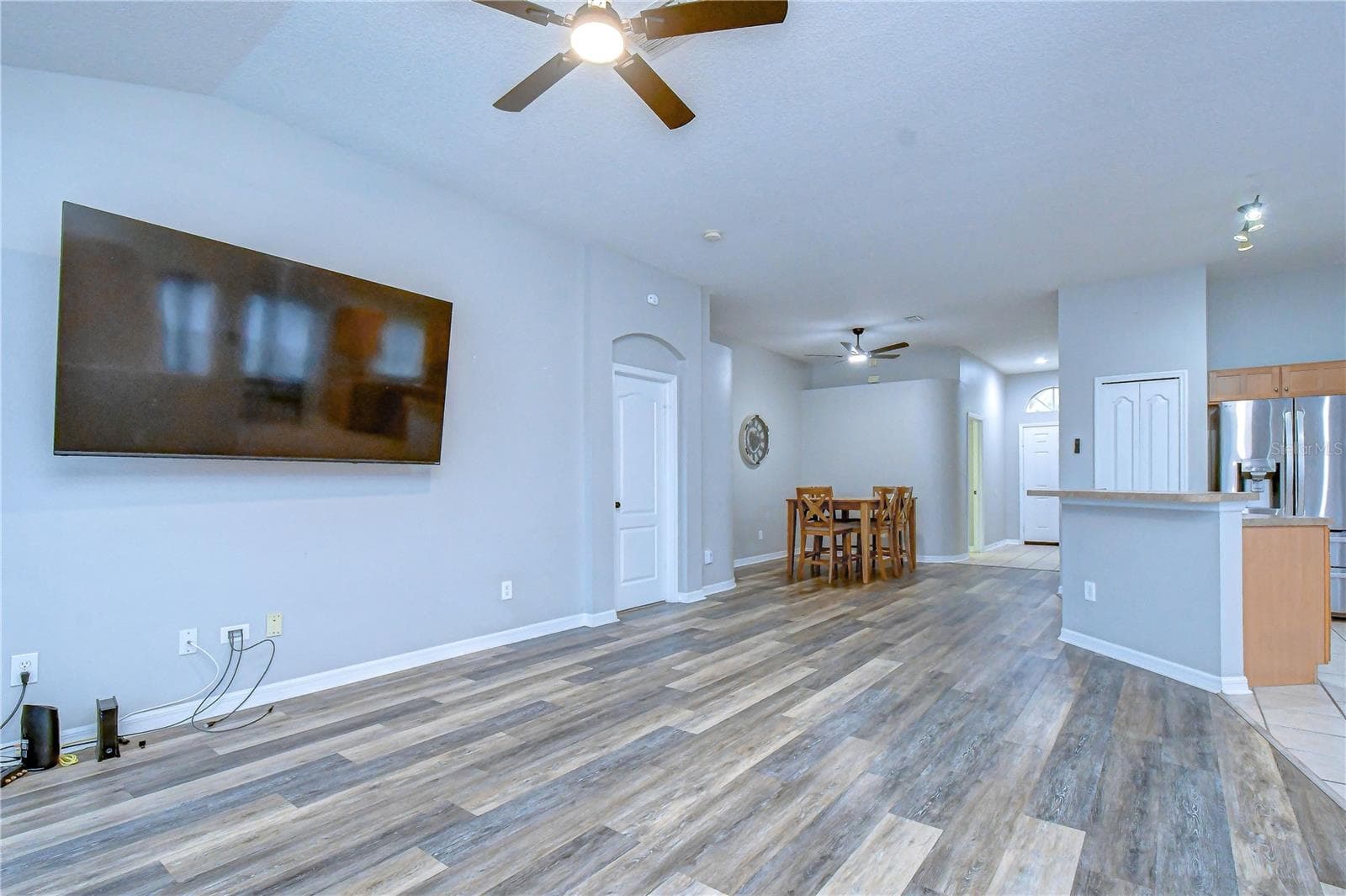 Functional laundry room with upper storage cabinets and direct exterior access. - 11117 RODEO LN, RIVERVIEW