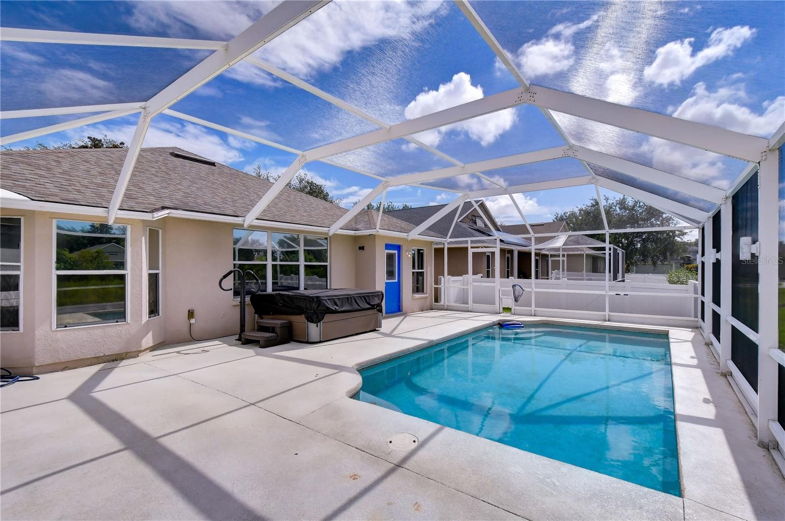 Five-person saltwater hot tub with convenient lid lift, added in 2025. - 11117 RODEO LN, RIVERVIEW