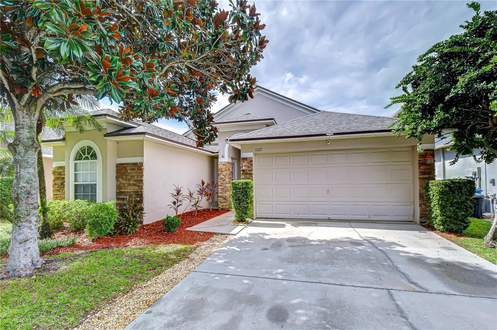 Attached two-car garage with new storage racks installed in 2026. - 11117 RODEO LN, RIVERVIEW