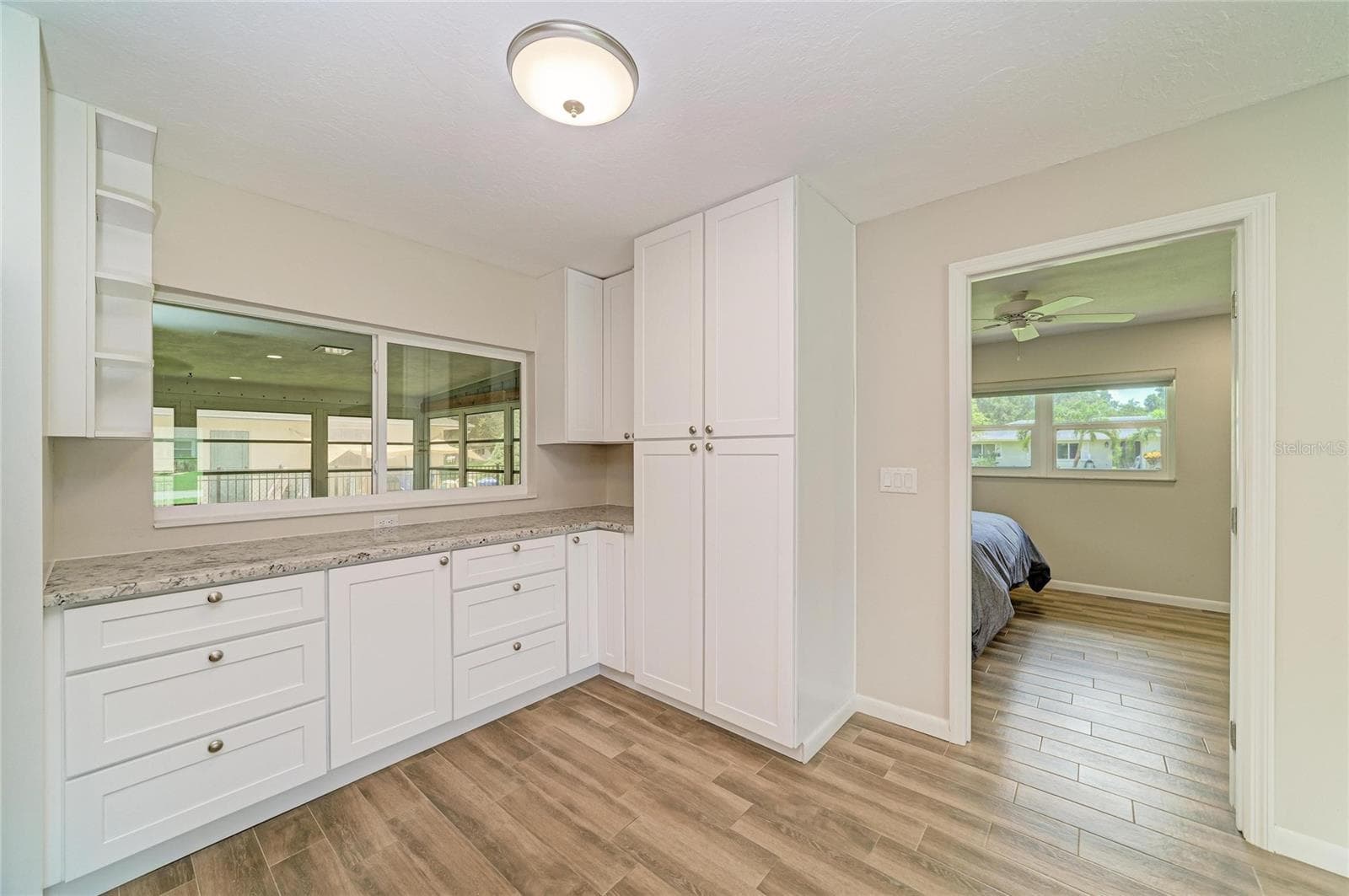 Additional cabinetry, pantry storage with roll-out drawers, and a custom stand mixer cabinet. - 2011 37TH ST W, BRADENTON