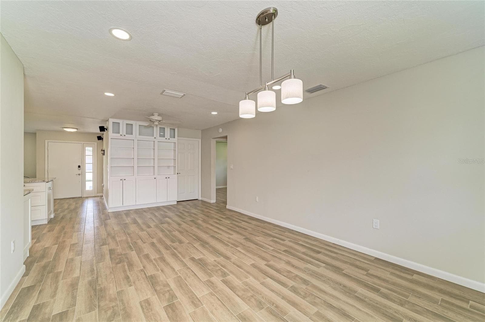 Large dining room off the kitchen with built-in shelves and cabinets. - 2011 37TH ST W, BRADENTON