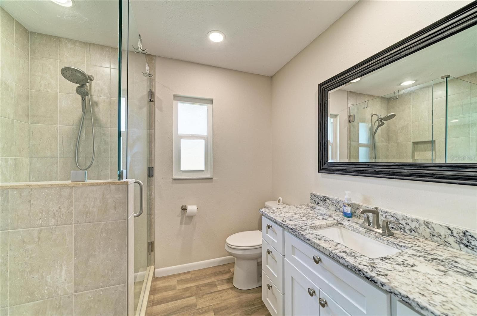 Ensuite bath with walk-in shower, granite counters and walk-in closet. - 2011 37TH ST W, BRADENTON
