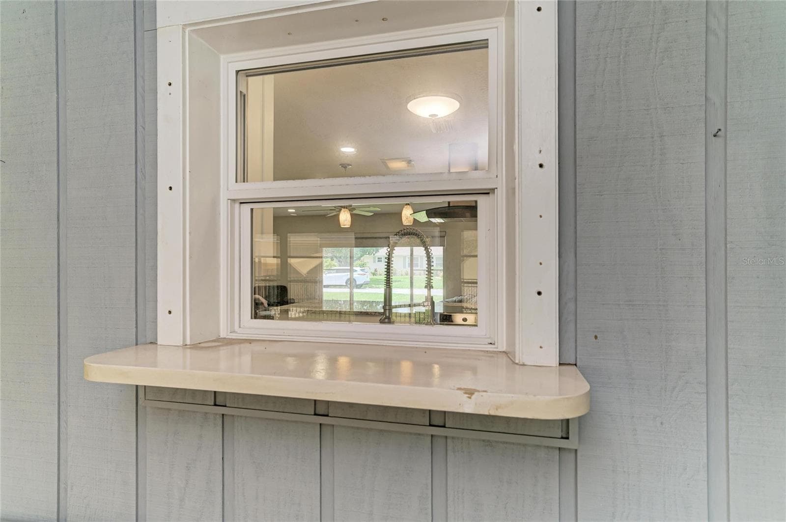 Kitchen pass-through window to Air conditioned Florida room. - 2011 37TH ST W, BRADENTON