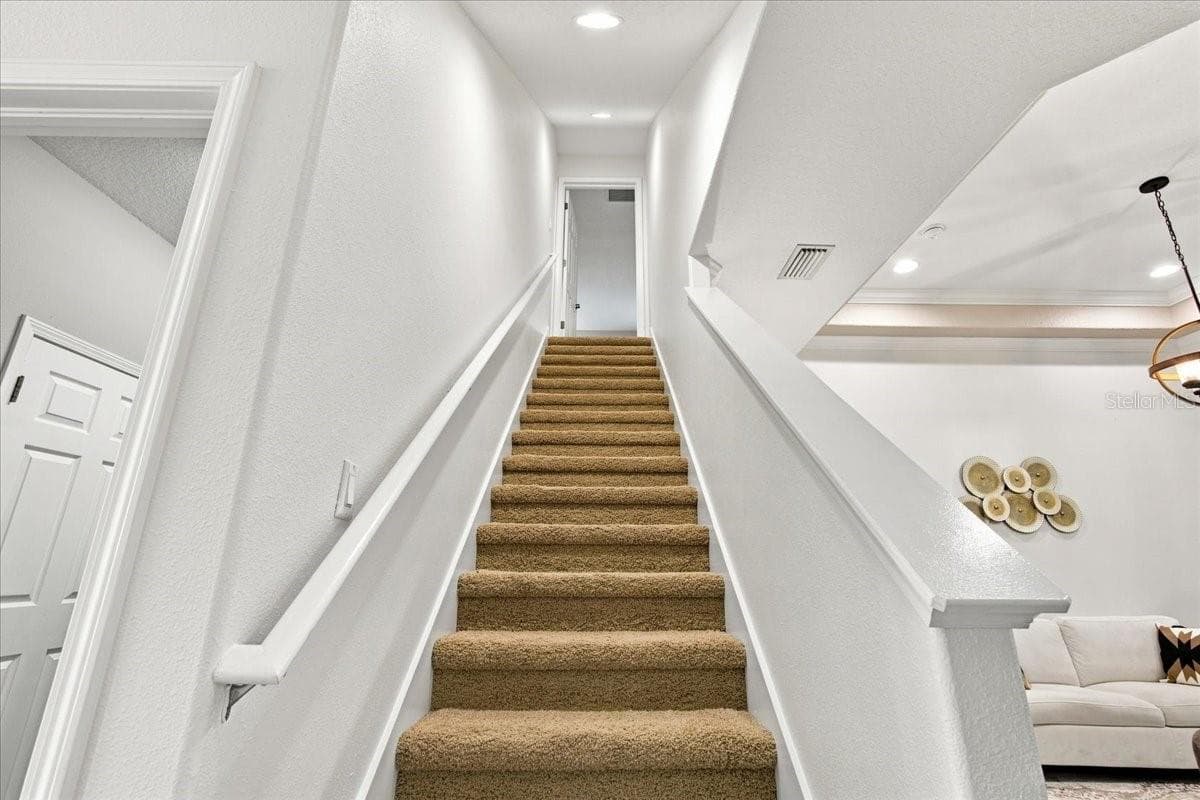 Stairs leading up to the giant bedroom / movie room / game room / etc - 4508 GRAND LAKESIDE DR E, PALM HARBOR