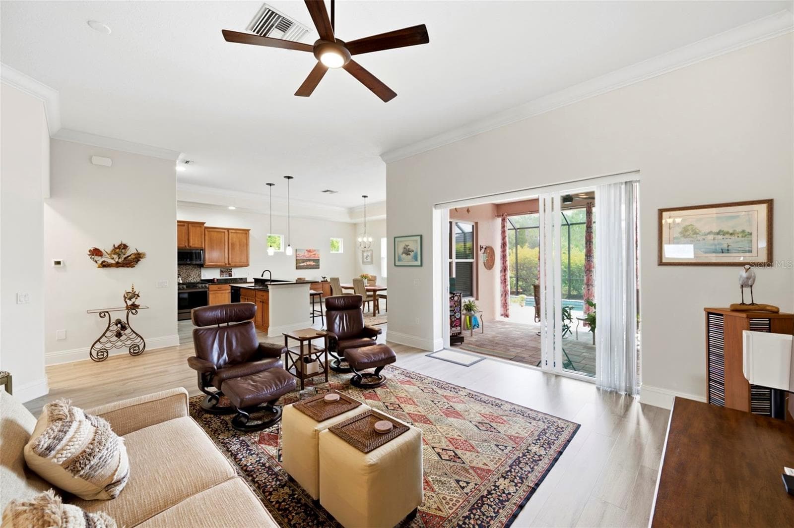 The sliders from the living space open out to the lanai - 3850 CREEKSIDE PARK DR, PARRISH