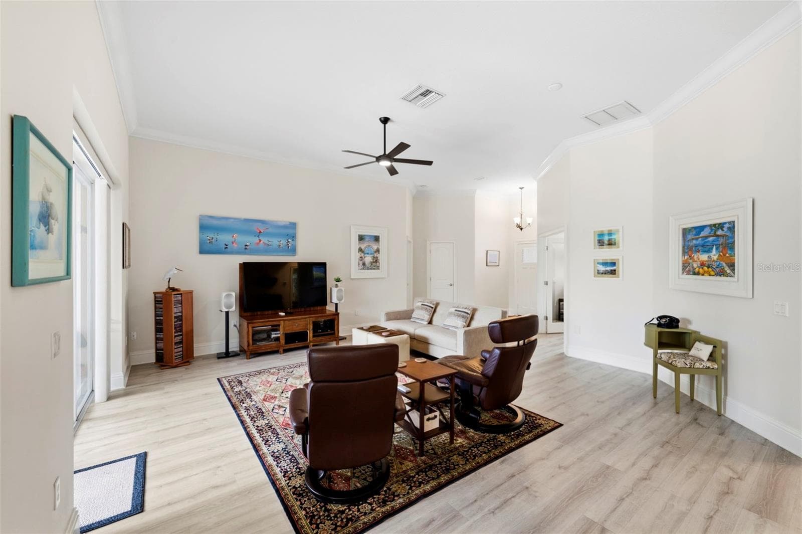The living room features a super silent Minka DC fan - 3850 CREEKSIDE PARK DR, PARRISH