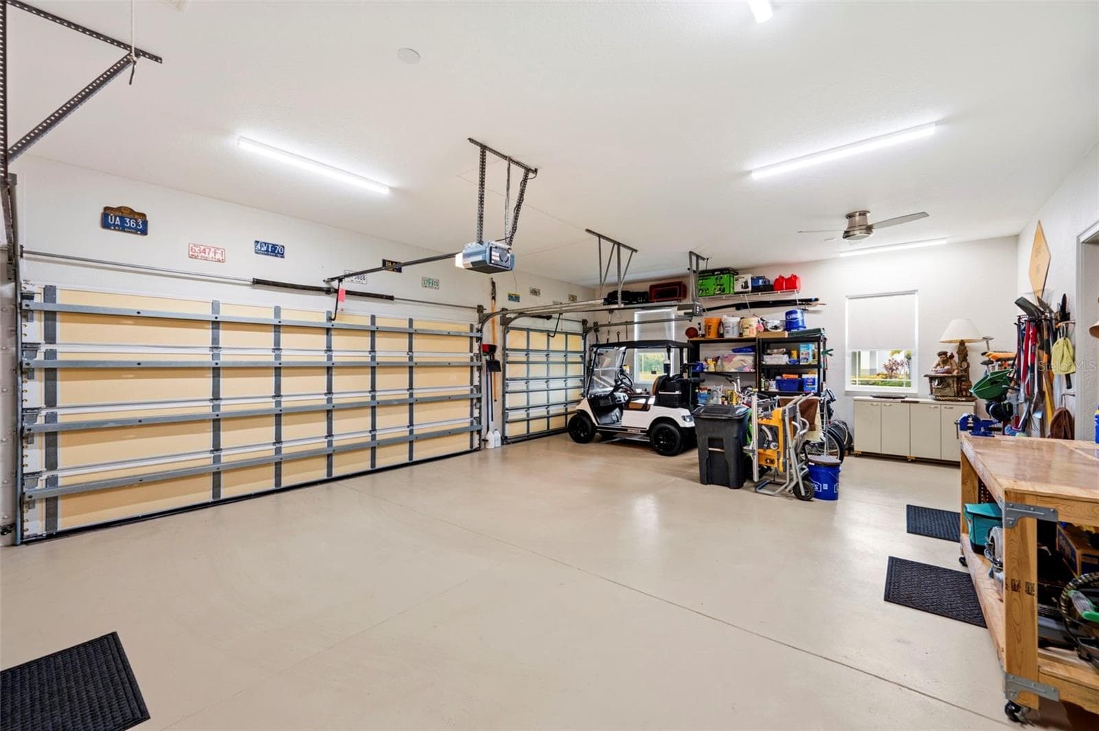 The garage is finished with drywall, baseboards, ceiling fan, epoxy floor and Air Conditioning - 3850 CREEKSIDE PARK DR, PARRISH