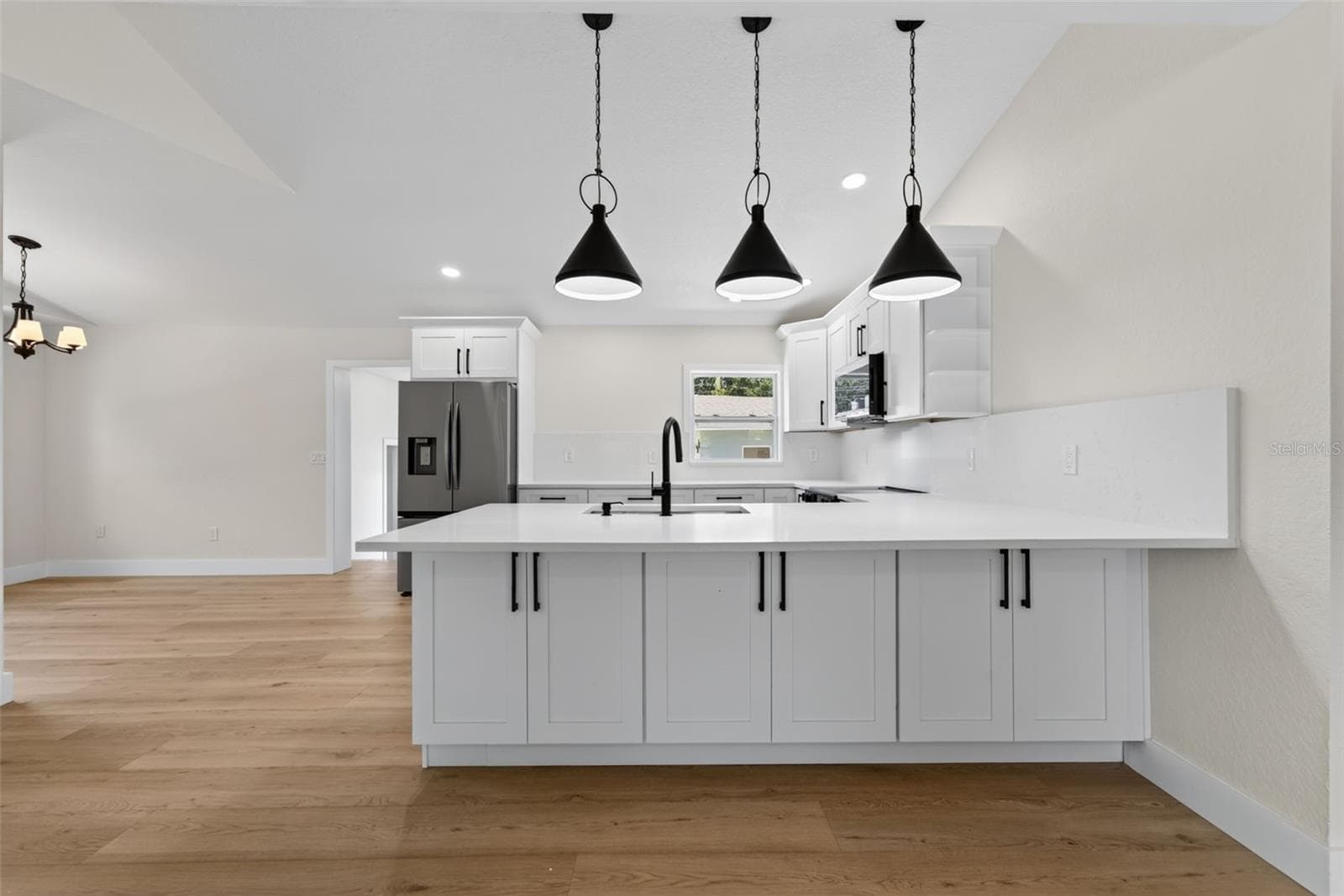Dramatic pendant lights over the breakfast bar with additional storage below - 5217 18TH AVE S, GULFPORT