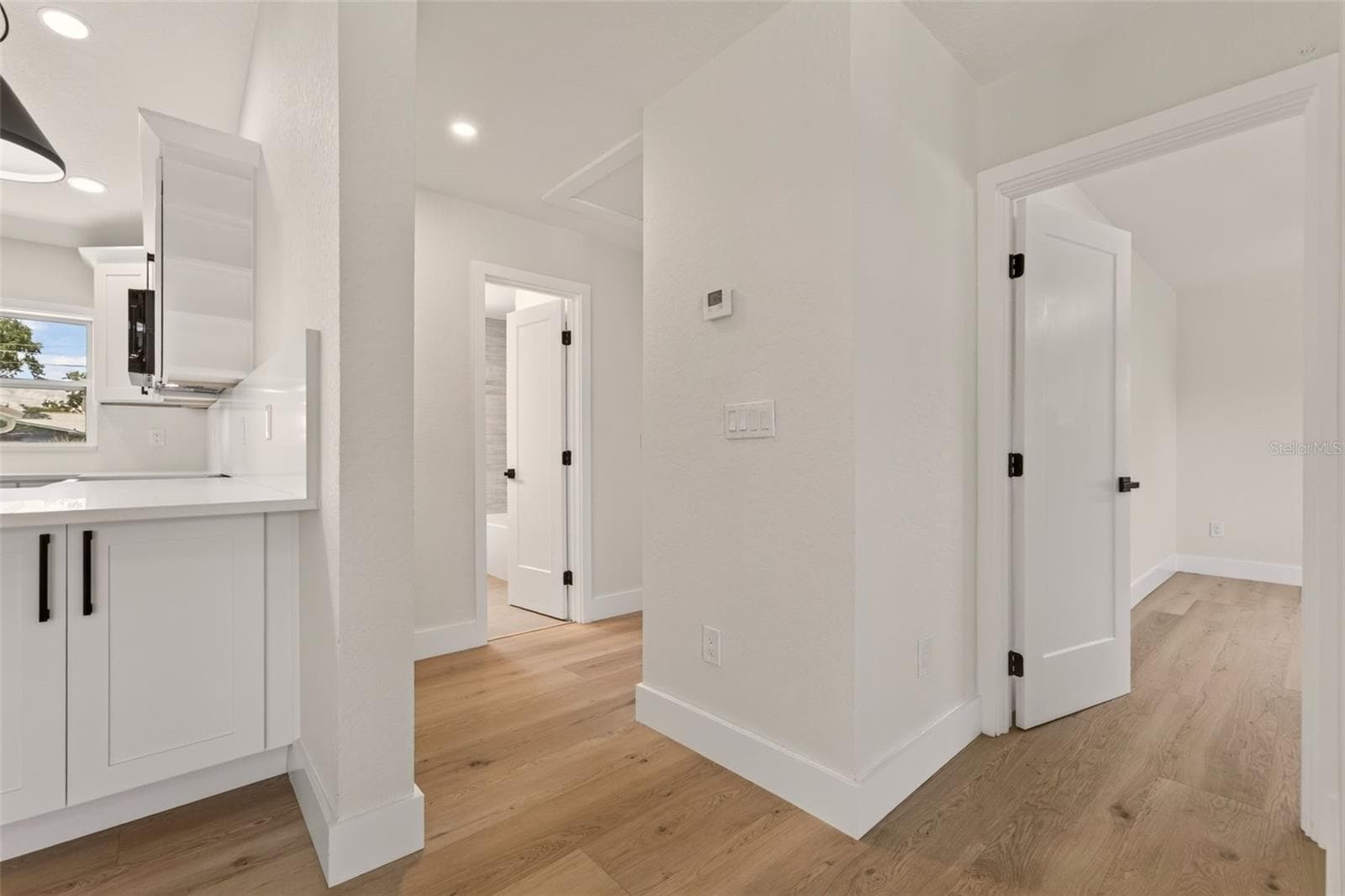 Hallway off living room and kitchen to 2 additional bedrooms and a hallway bathroom - 5217 18TH AVE S, GULFPORT
