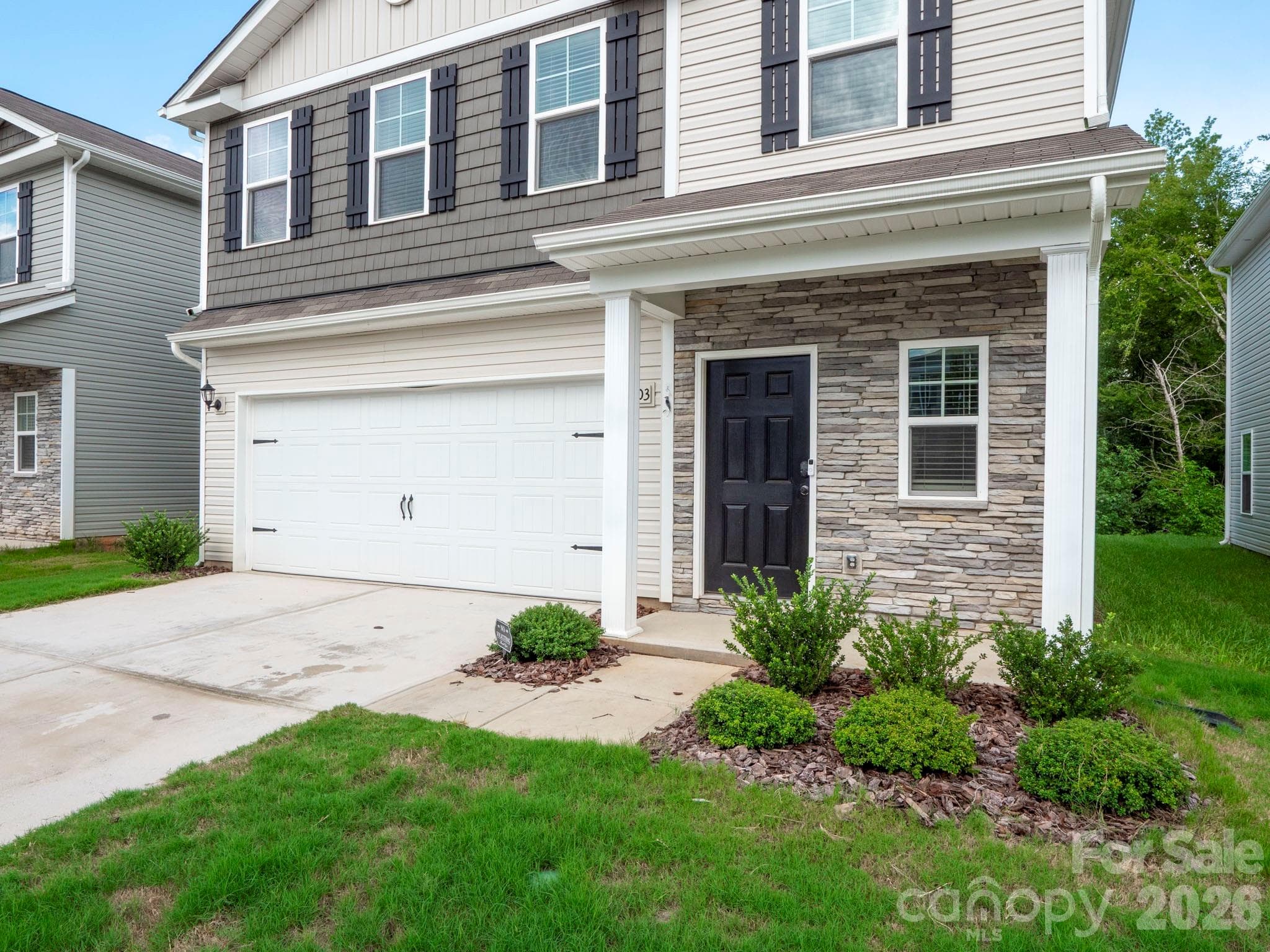 Two car attached garage, front porch with room for chairs. - 7203 Stoney Wood Lane, Charlotte