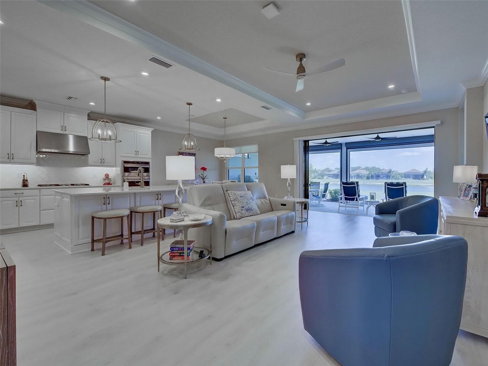 The beautiful tray ceiling extends into the great room which is wide open to the kitchen and lanai. - 5616 SCARLOTTI ST, NOKOMIS