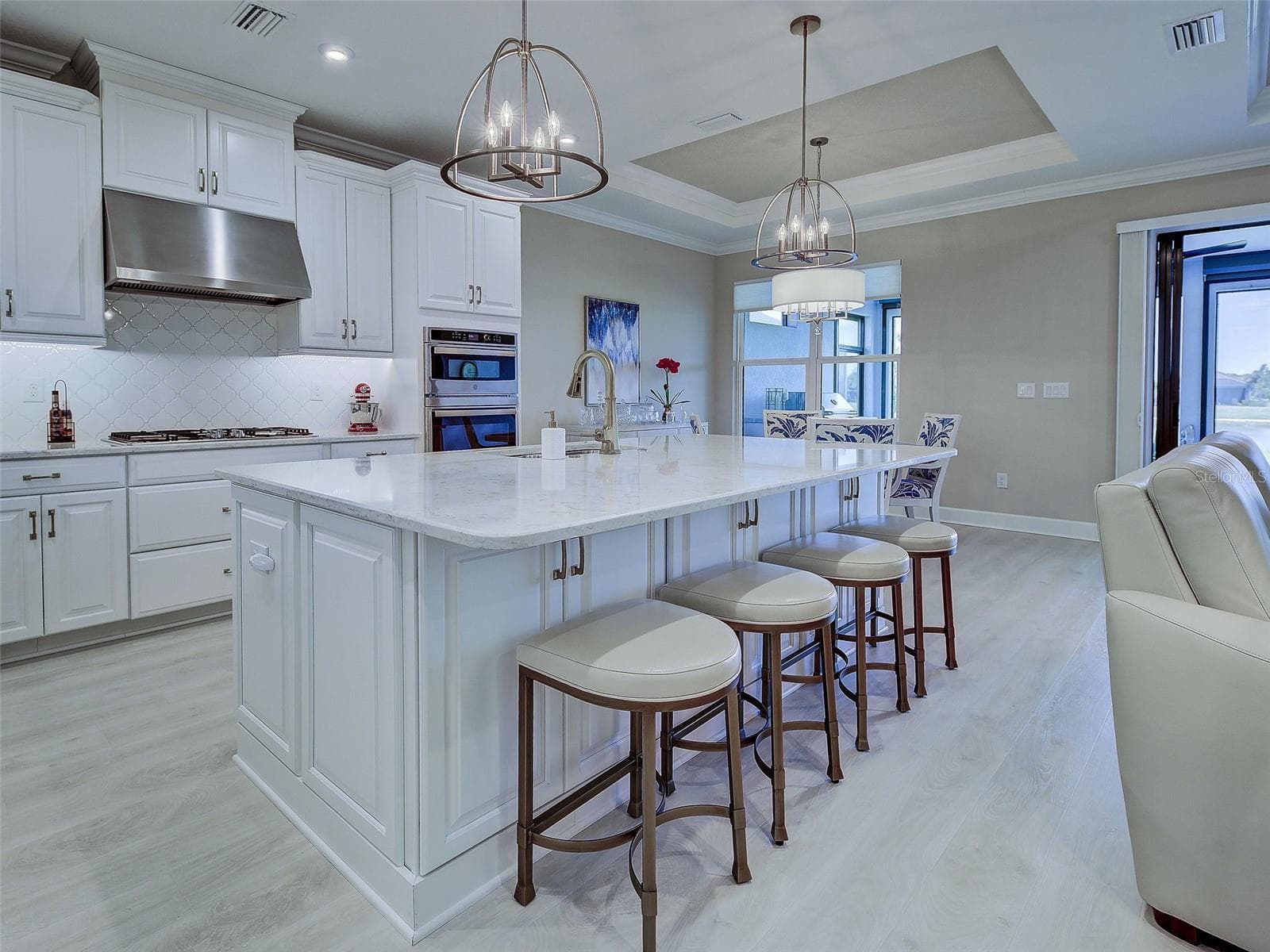 A large island with seating for four is a kitchen focal point. - 5616 SCARLOTTI ST, NOKOMIS