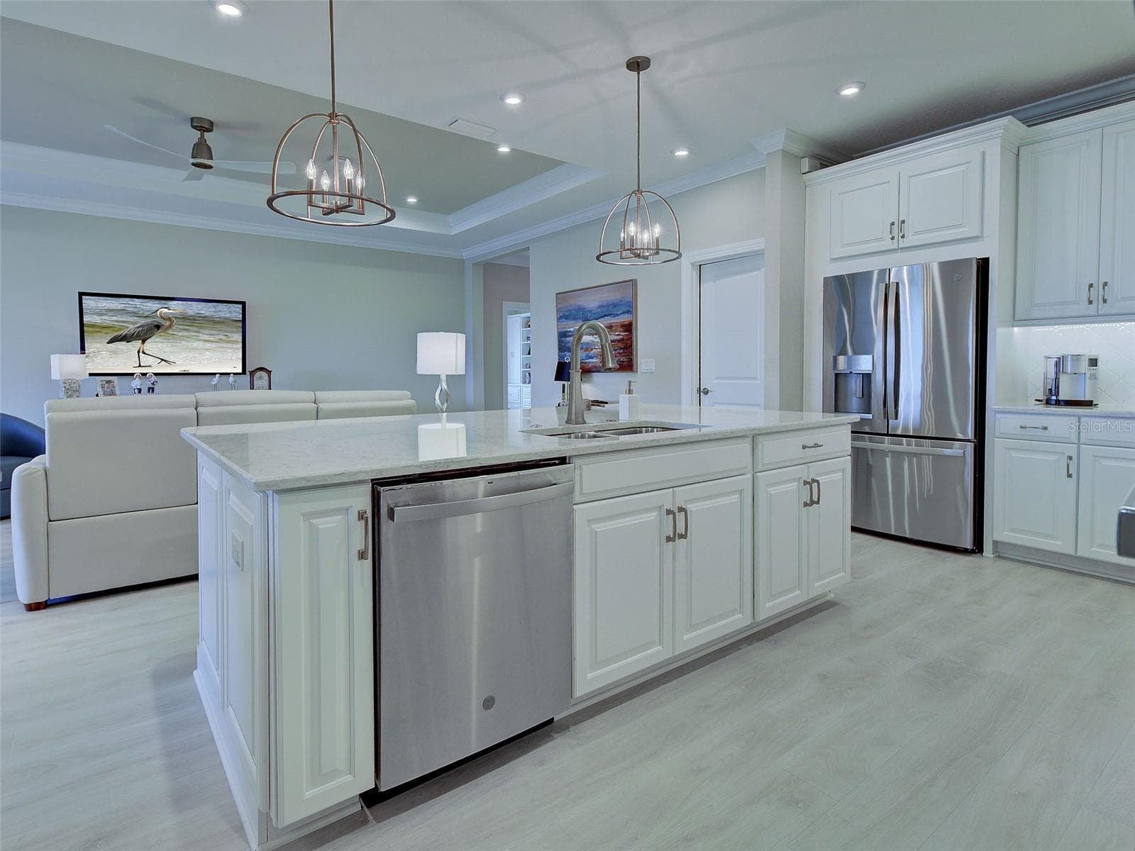 Beautiful white cabinets, gleaming stainless-steel appliances and tasteful countertops complement the chef's kitchen. - 5616 SCARLOTTI ST, NOKOMIS