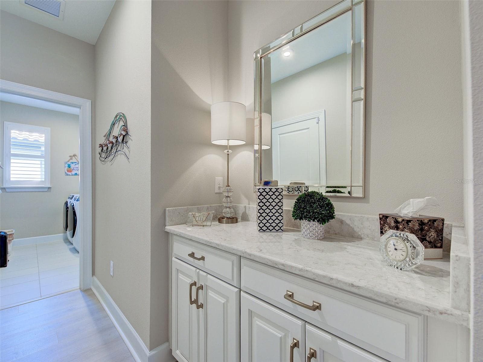 There are extra cabinets and counter space adjacent to the laundry room. - 5616 SCARLOTTI ST, NOKOMIS