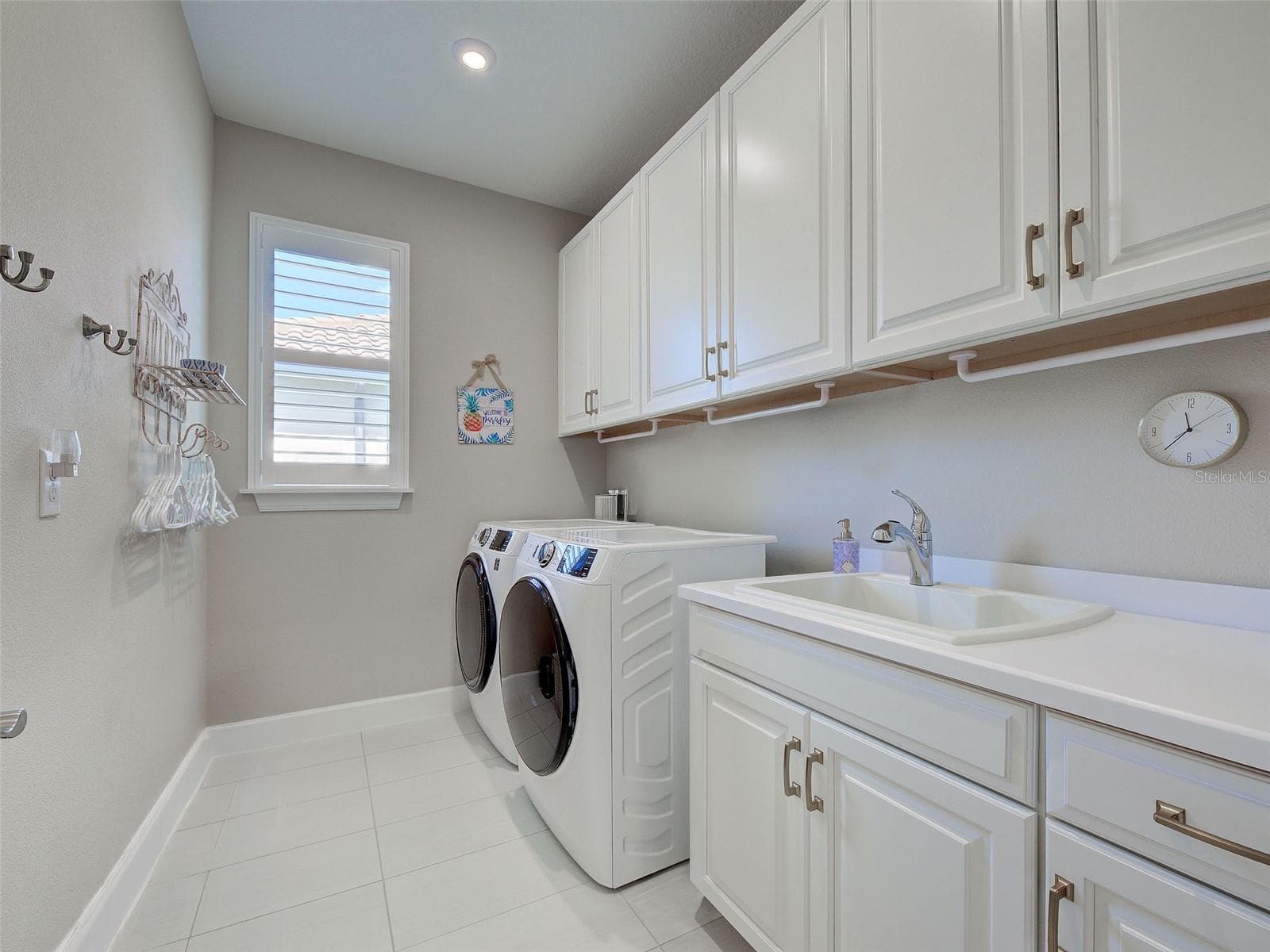 Plenty of cabinets for storage in the laundry room, which also has a sink. - 5616 SCARLOTTI ST, NOKOMIS