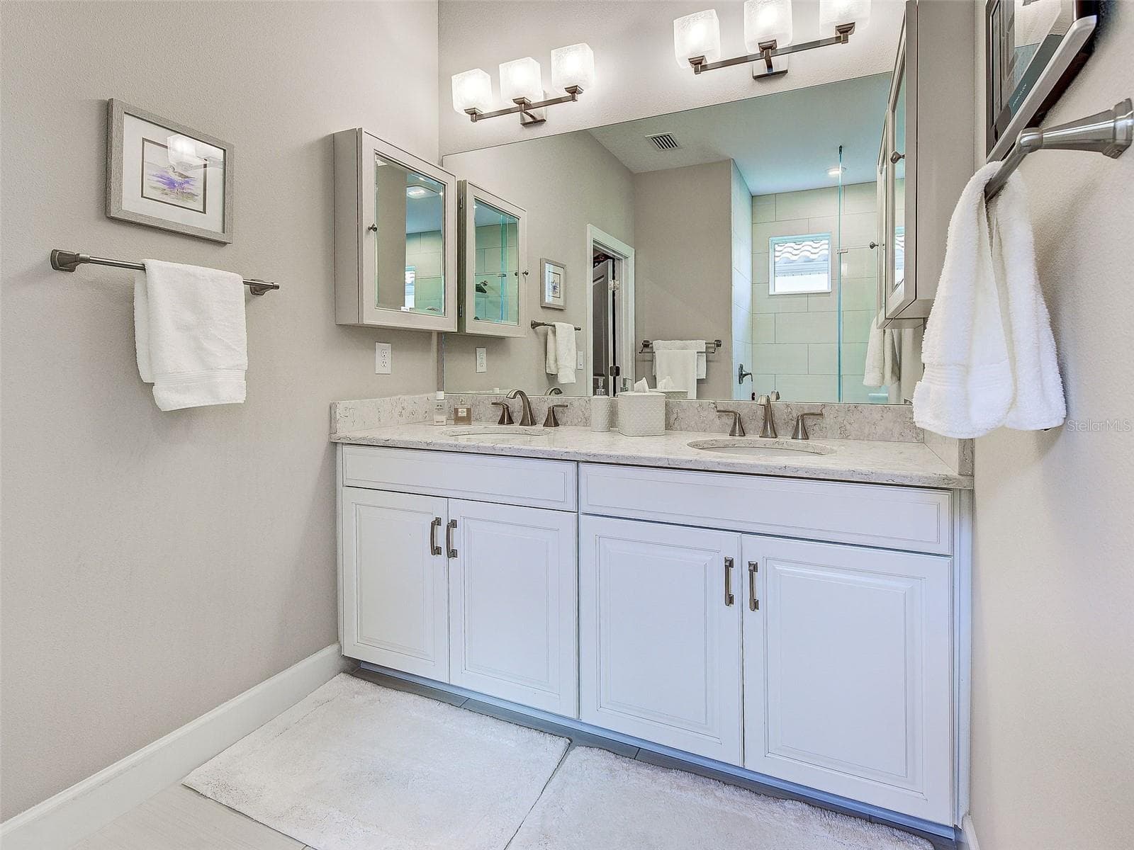 Dual sinks and a large mirror round out the primary bathroom. - 5616 SCARLOTTI ST, NOKOMIS