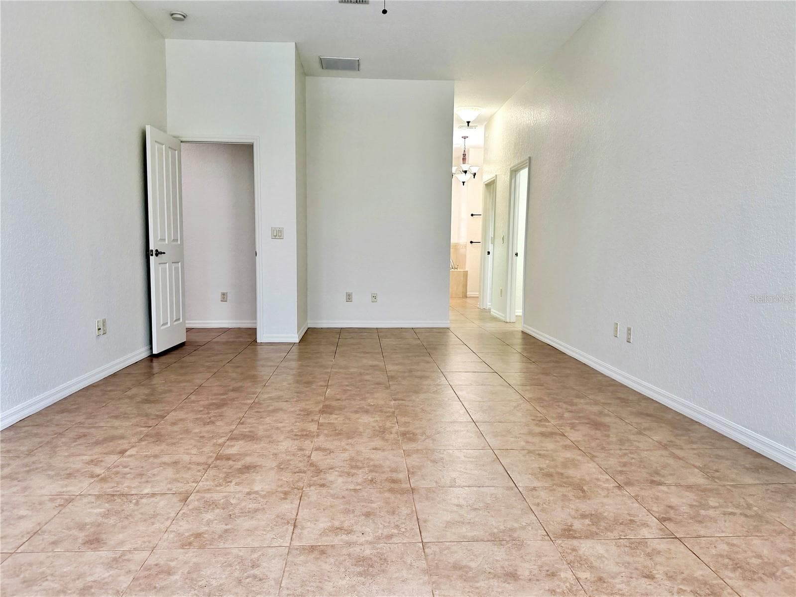 Primary Bedroom looking toward entry door and bathroom - 24087 TWISTER LN, BROOKSVILLE