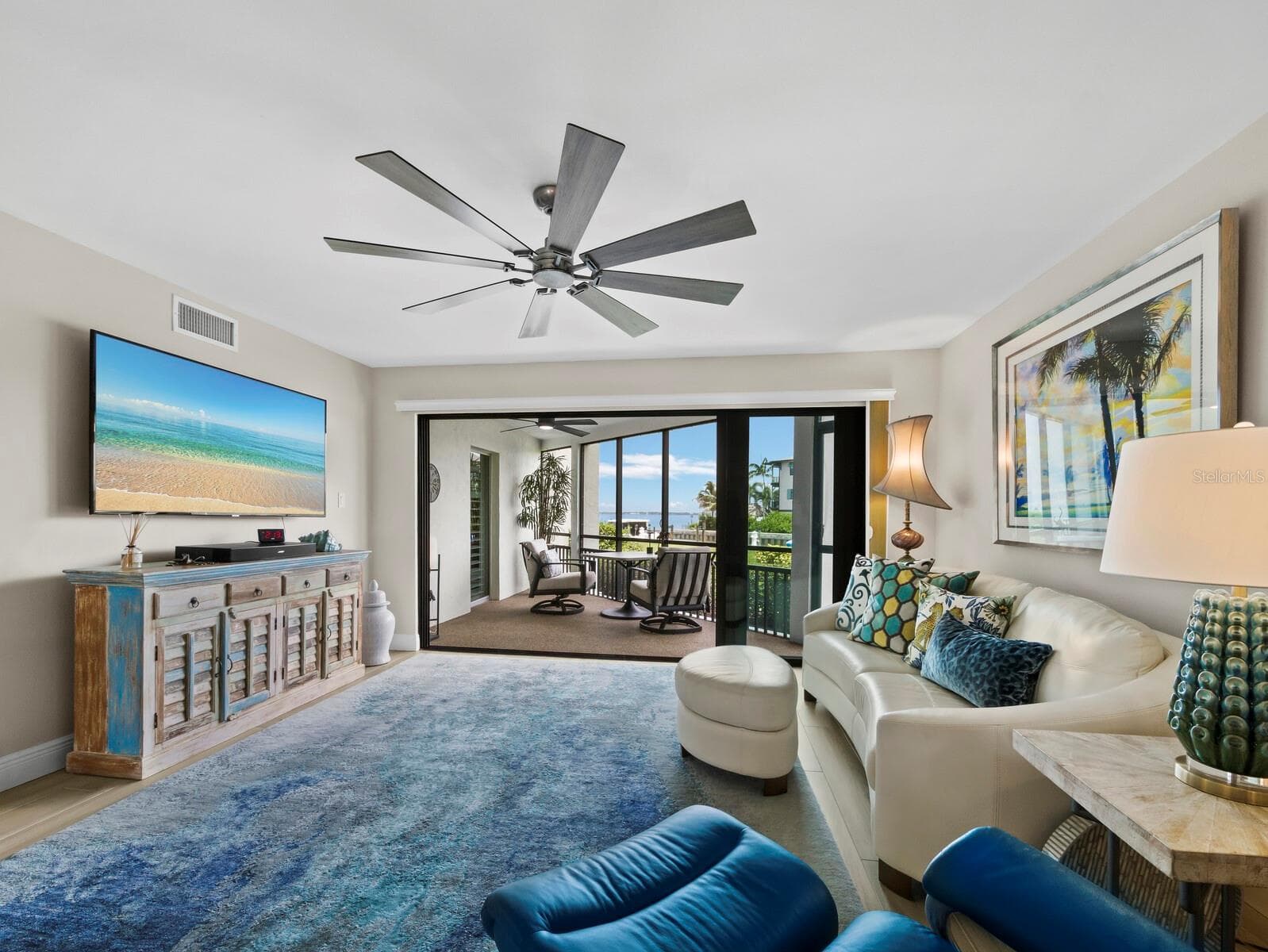 Living room across the lanai to the bay - 448 GULF OF MEXICO DR #A104, LONGBOAT KEY