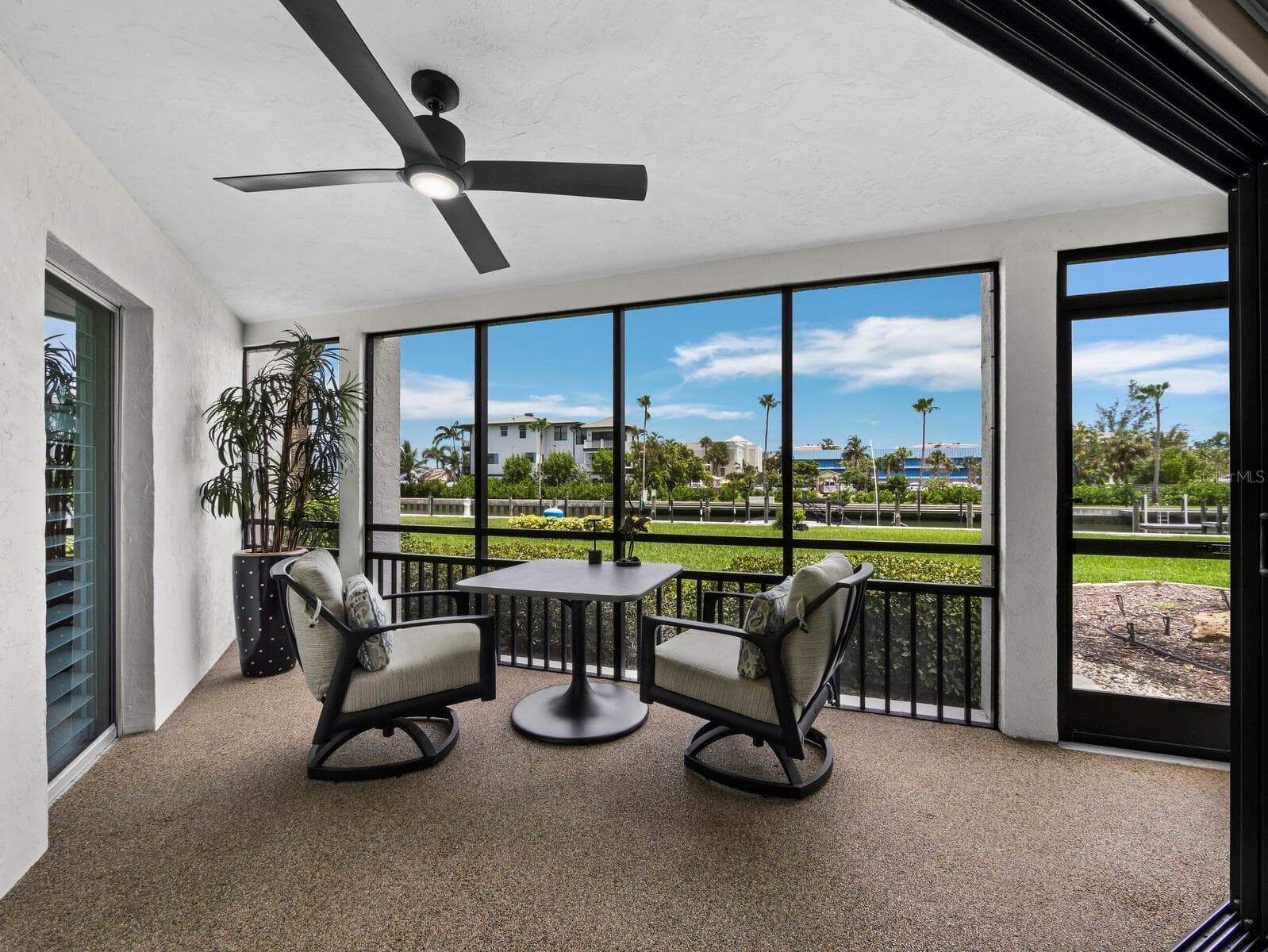 Views of the harbour from the lanai. You can also walk out to the pool from either this door or the front entry! - 448 GULF OF MEXICO DR #A104, LONGBOAT KEY