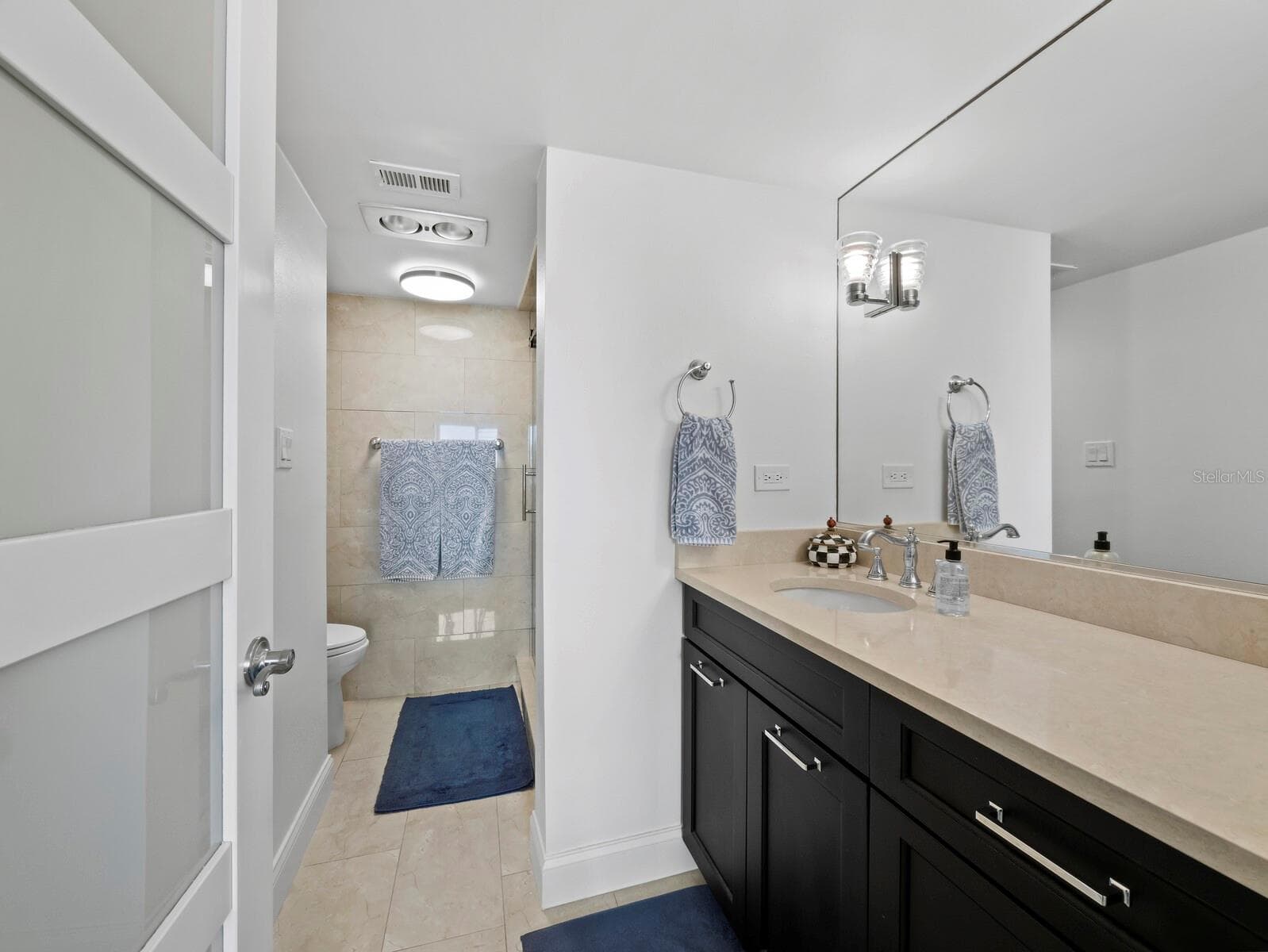 Ensuite bath in the Primary Bedroom...shower is just beyond the sink and cabinet! - 448 GULF OF MEXICO DR #A104, LONGBOAT KEY