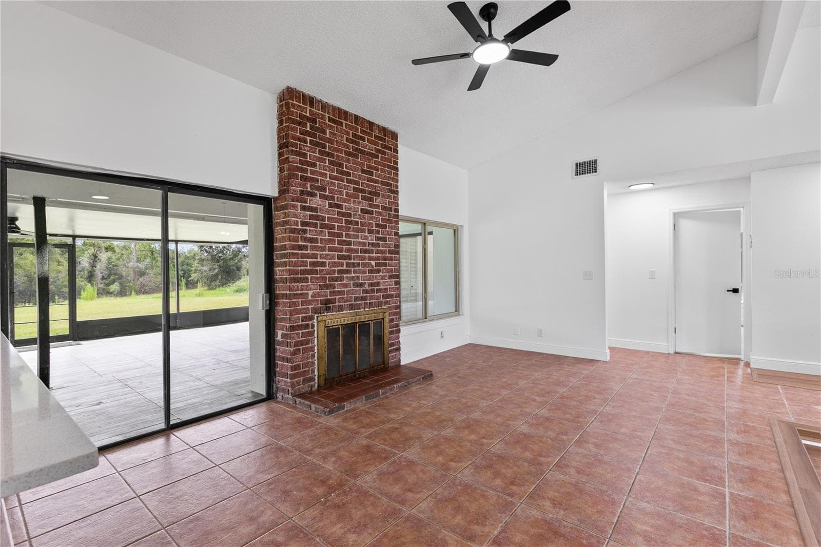 Family room with brick fireplace - 714 DIVOT LN, POINCIANA