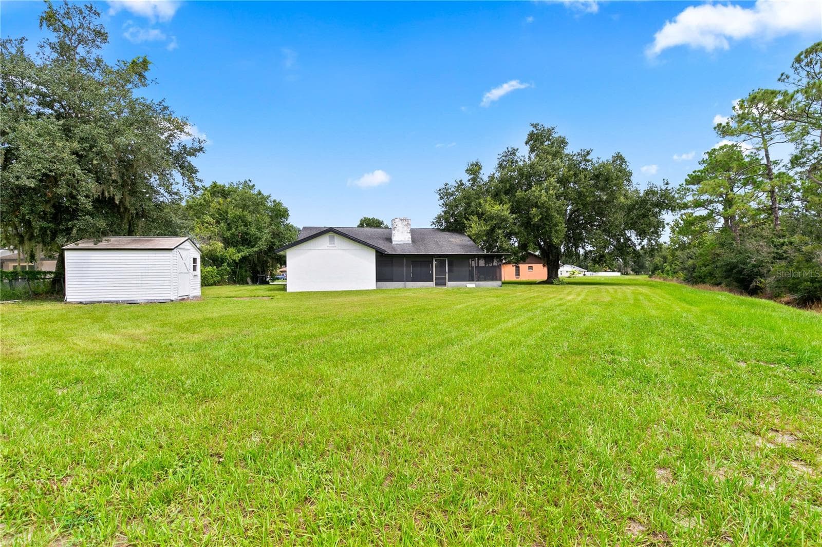 View from the backyard to the house - 714 DIVOT LN, POINCIANA