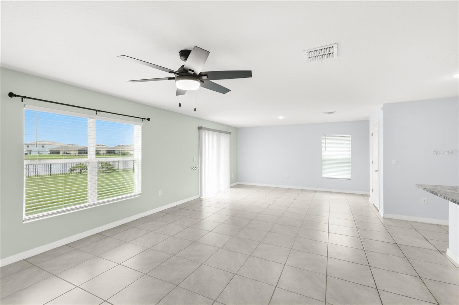 Living room into dining room - 10116 CHARLOTTE DR, PARRISH