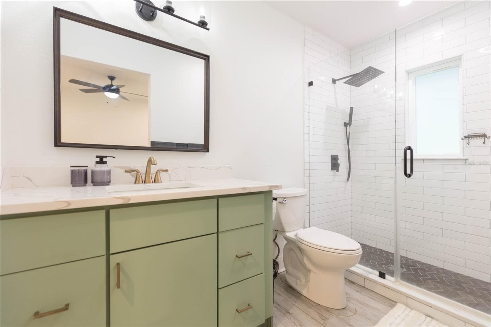 Primary bathroom with quartz countertops, framed mirror and stunning shower - 2705 LAKEVILLE DR, TAMPA
