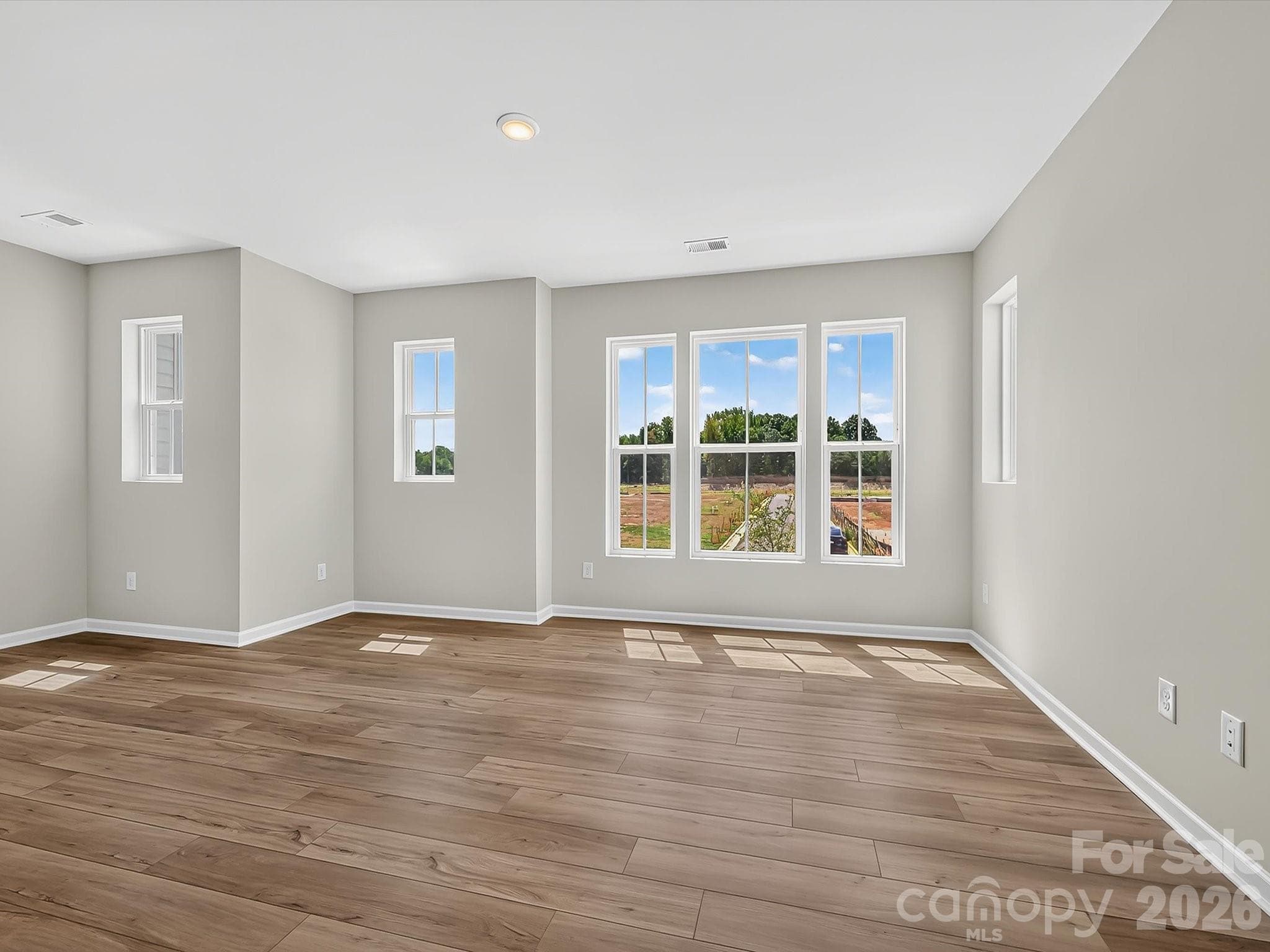 Living Room with an abundance of windows for Natural Lighting - Charlotte