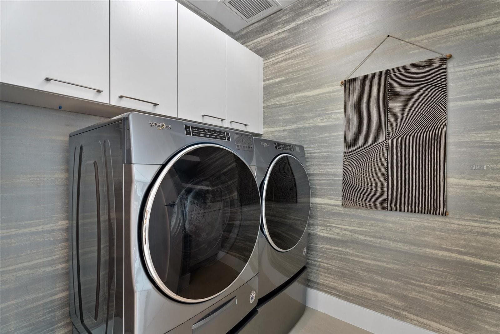 Practical storage cabinets in laundry room, across from kitchen. - 1155 N GULFSTREAM AVE #807, SARASOTA