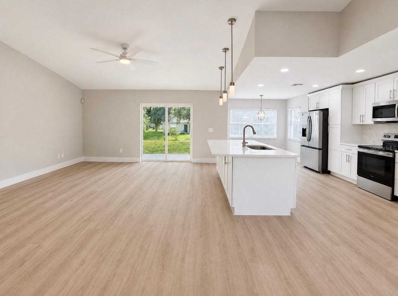 Living Room with slider doors that lead to patio and enormous back yard - 10814 CRESCENDO LOOP, CLERMONT
