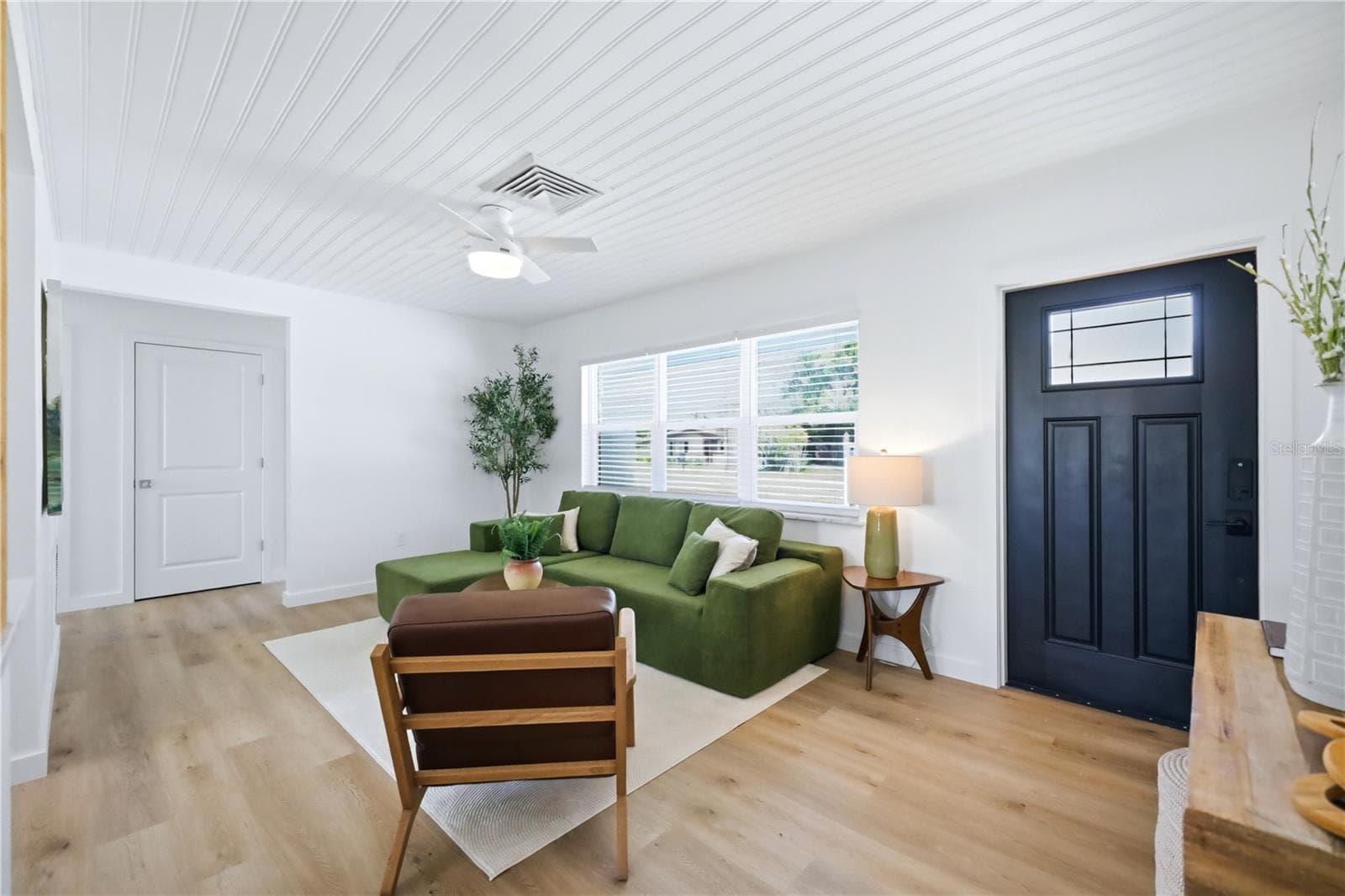 Updated front entry with modern impact door and bright open family room - 6103 CARLTON AVE, SARASOTA