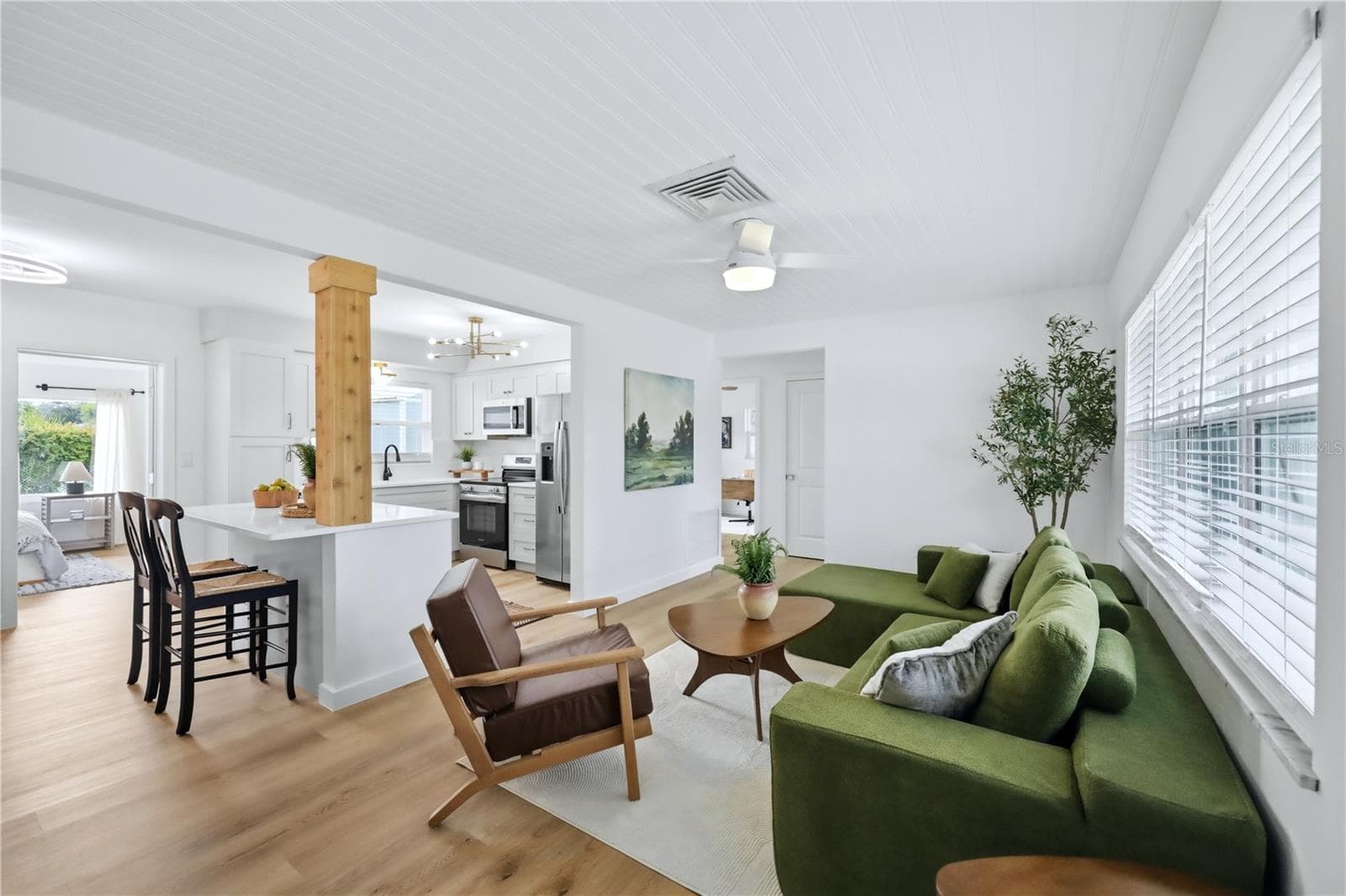 Fully renovated open-concept living area with new flooring - 6103 CARLTON AVE, SARASOTA
