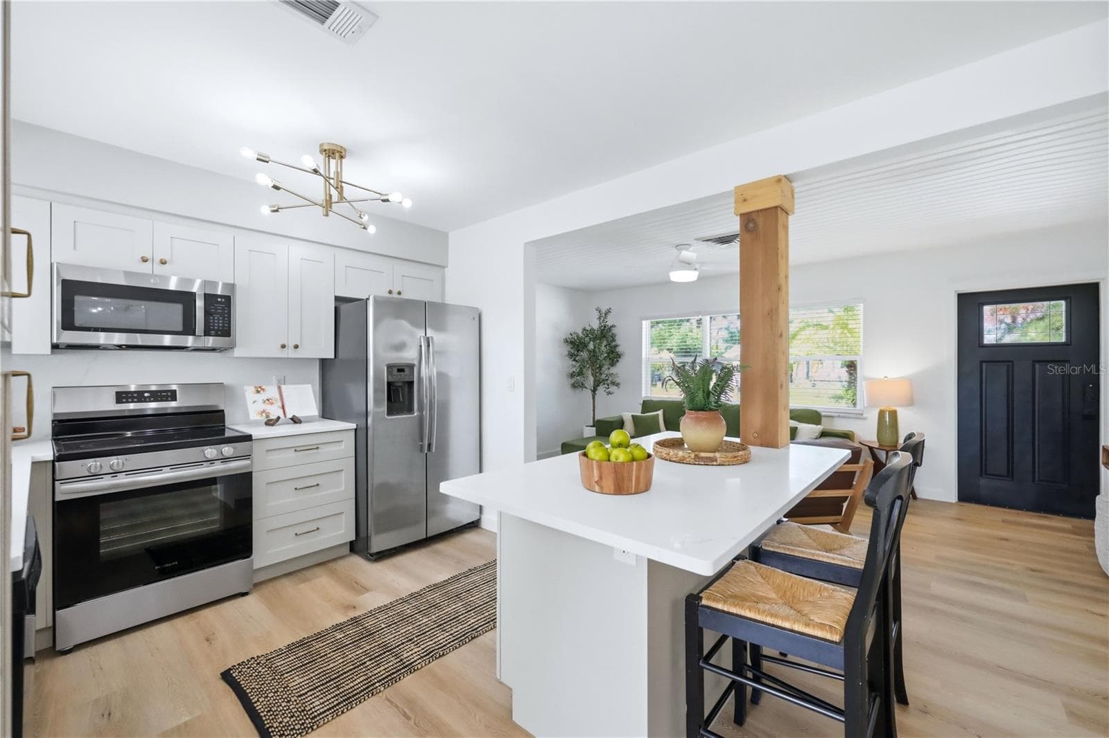 Modern renovated kitchen featuring large island, and new cabinetry - 6103 CARLTON AVE, SARASOTA
