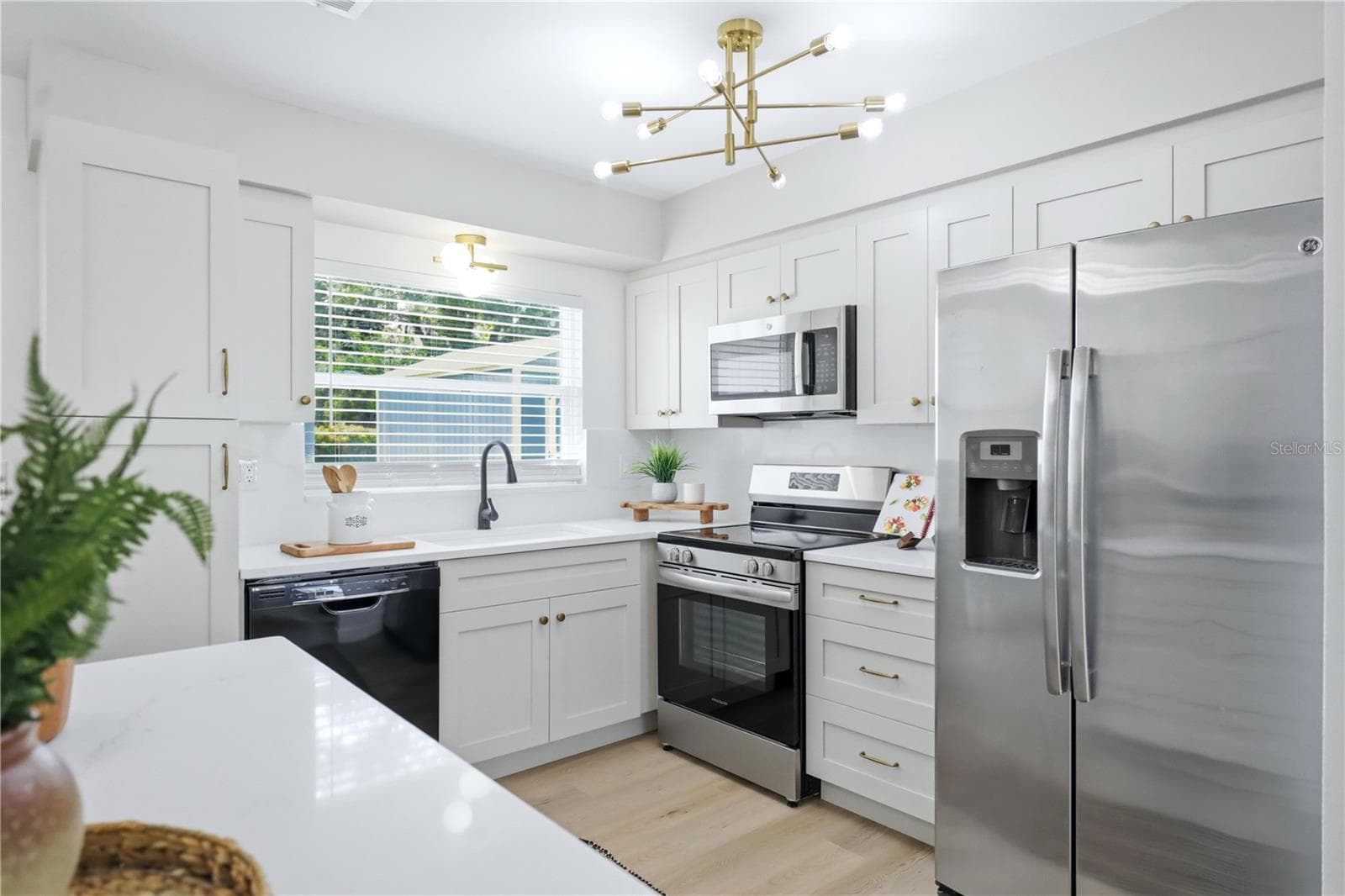 Updated kitchen with new white cabinetry, and modern finishes - 6103 CARLTON AVE, SARASOTA