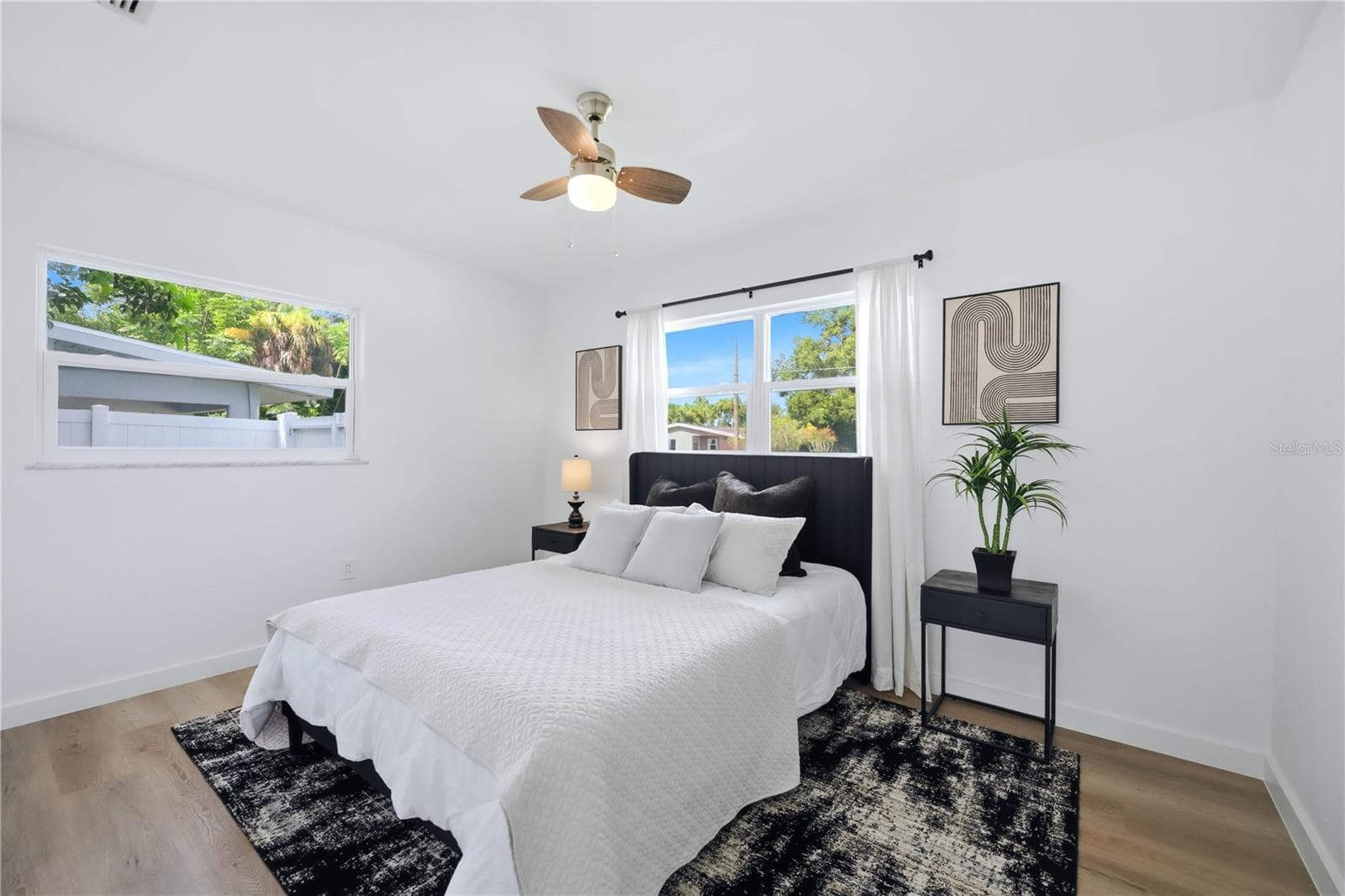 Bright guest bedroom with natural light, ceiling fan and neutral finishes - 6103 CARLTON AVE, SARASOTA